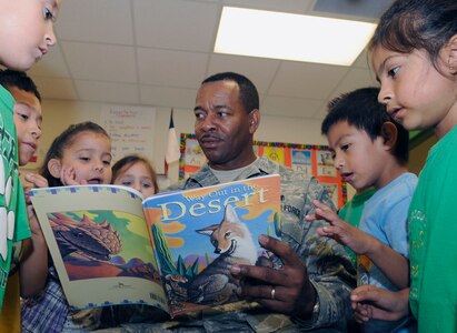 Chief Master Sgt. Rickey King, 59th Medical Wing mental health, reads to kindergarten children at Schertz Elementary School in Schertz, Texas, April 8.  Military members from Ft. Sam Houston, Randolph AFB and Lackland AFB visited Schertz Elementary School as part of a Joint Base San Antonio initiative to visit  schools in the area to encourage reading. (U.S. Air Force Photo/Don Lindsey)