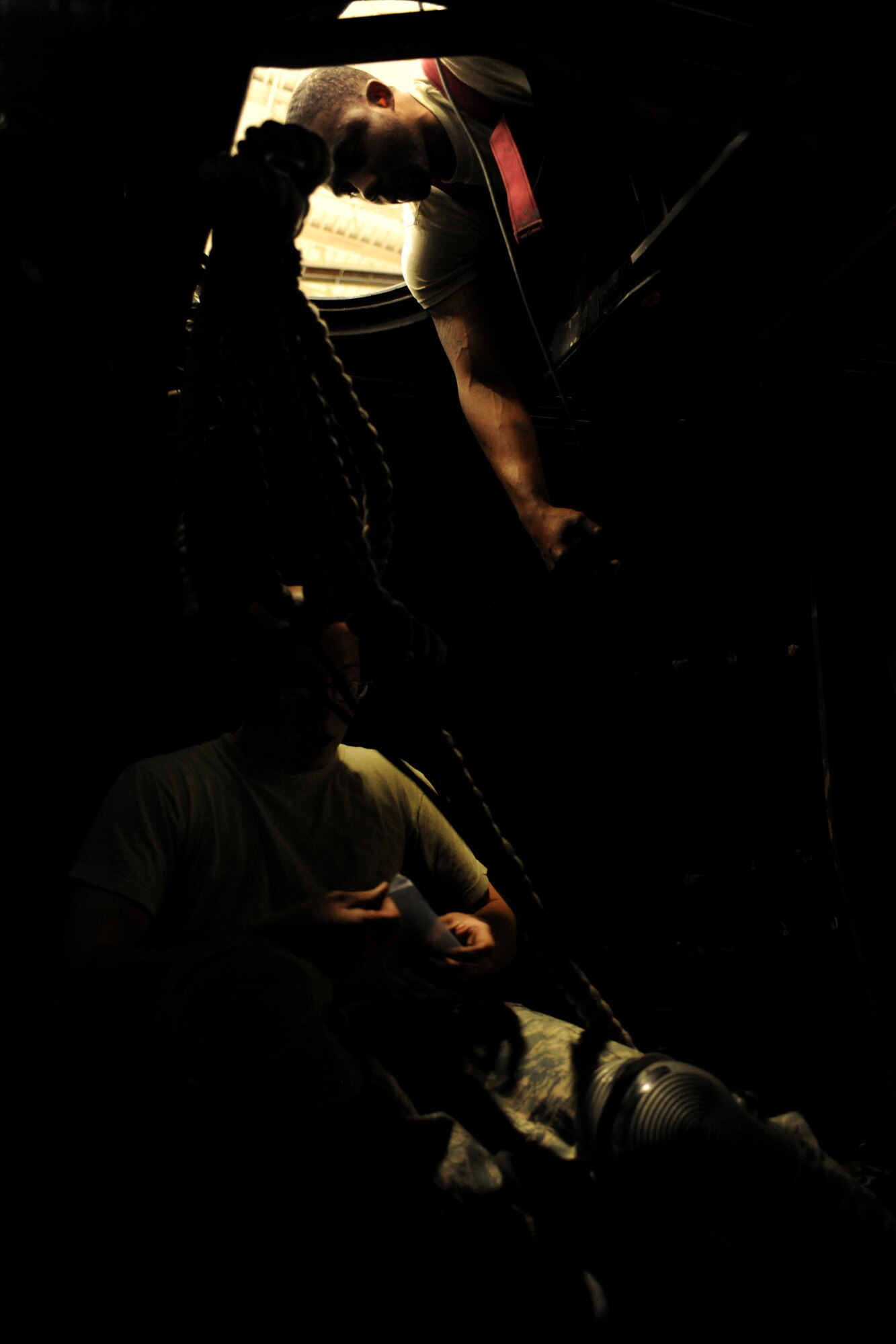 Staff Sgt. Ronald Golden, 23rd Equipment Maintenance Squadron sheet metal, reaches for a tool as Senior Airman Caleb Powell, 23rd EMS sheet metal, performs a beam repair on an HC-130P Combat King during routine maintenance at Moody Air Force Base, Ga., April 7. Personnel from the 23rd EMS sheet metal continually work to fight corrosion from occurring in all three of the aircraft featured at Moody.  (U.S. Air Force photo/Airman 1st Class Benjamin Wiseman)(RELEASED)