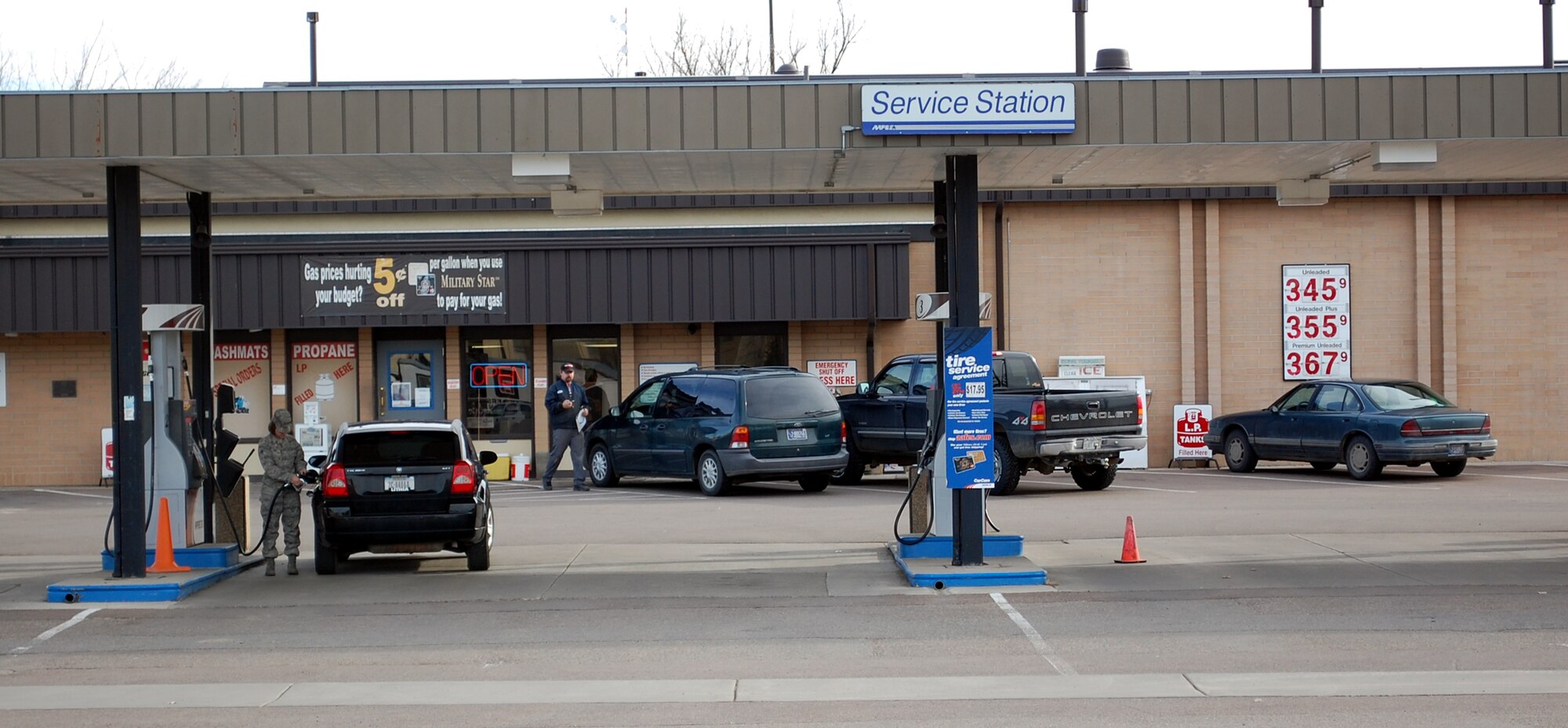 A military member fills her gas tank at the base service station April 5. Gas pricing is not regulated by the Army and Air Force Exchange Service, however they can offer discounts when members use thier Military Star Card to pay for their gasoline purchases. (U.S. Air Force photo/Valerie Mullett)
