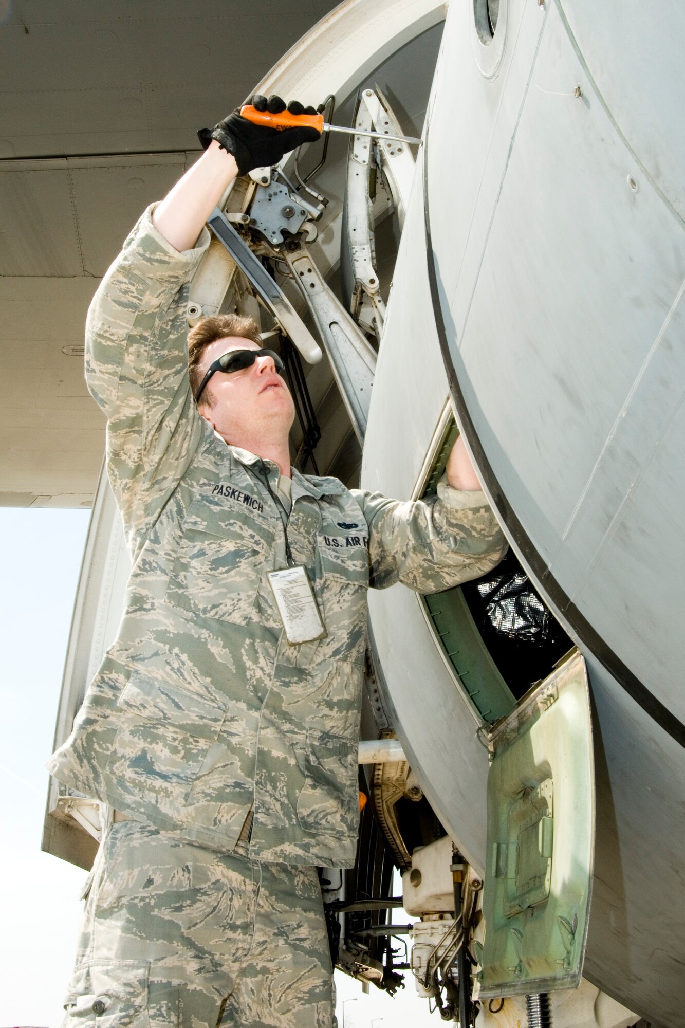 Tech. Sgt. Devon Paskewich, a crew chief at the 167th Airlift Wing, seals a panel on the side of a C-5 aircraft, at the Martinsburg, W.Va. unit on April 7, 2011. The unit's C-5 aircraft have recently supported missions in Libya, Japan, Afghanistan, and Iraq, keeping both operations and maintenance personnel busy. (U.S. Air Force photo by MSgt Emily Beightol-Deyerle)