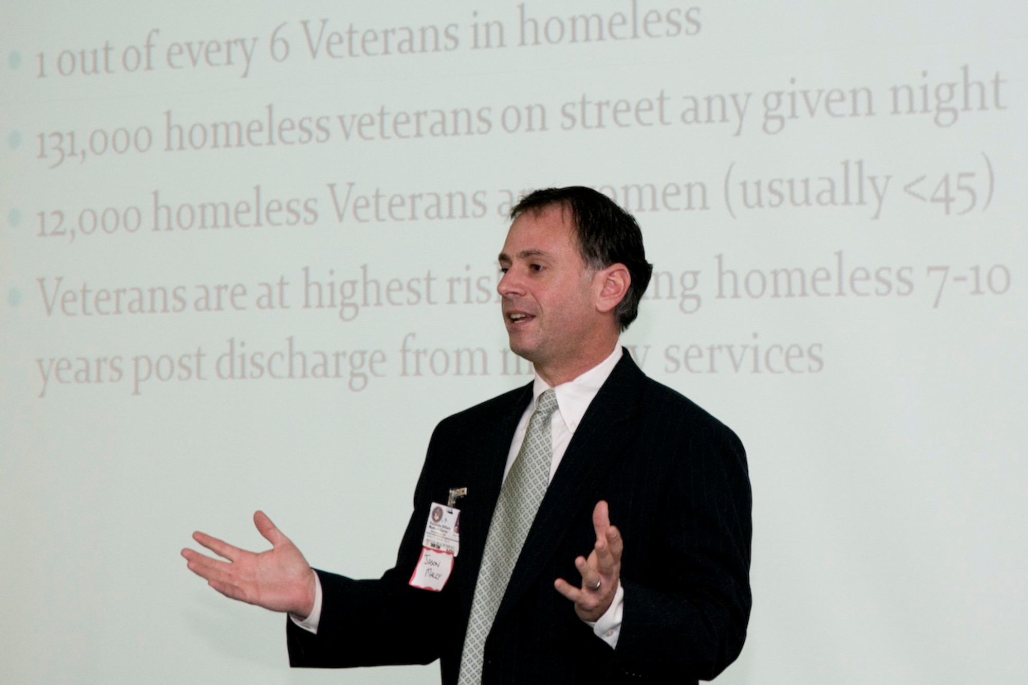 Dr. Jason Malcy, program director for the Domiciliary for Homeless Veterans  (DCHV)/GOALS program at the Veterans Administration Medical Center in Martinsburg, talks about the issue of veterans homelessness at the Inter-Service Family Assistance Committee of Eastern West Virginia’s February meeting at the 167th Airlift Wing in Martinsburg. (U.S. Air Force photo by Master Sgt. Emily Beightol-Deyerle)