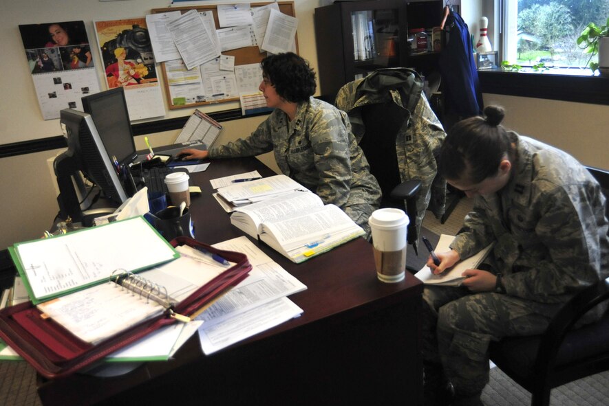 Capt. Jane Elzeftawy, left, and Capt. Andrea Hunwick, both assigned to the 62nd Airlift Wing Judge Advocate office, prepare for an upcoming trial March 29 at Joint Base Lewis-McChord, Wash. The 62nd AW/JA staff’s responsibilities include adverse actions, operations law, civil law, claims and legal assistance. (U.S. Air Force photo/Airman 1st Class Leah Young)