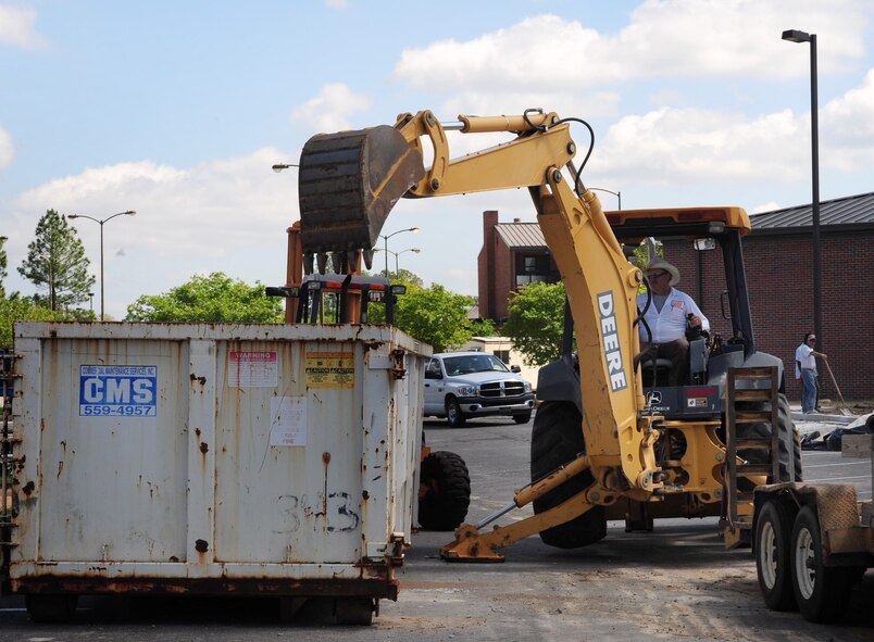 MOODY AIR FORCE BASE, Ga.--  A contractor  uses a fork lift to remove concrete from the Bowling Alley parking lot April 7. This is one of the many ongoing projects around the base as Moody continues to improve the buildings on base by renovating them to give Airmen a better quality of living. (U.S. Air Force photo/Senior Airman Stephanie Mancha)(RELEASED)