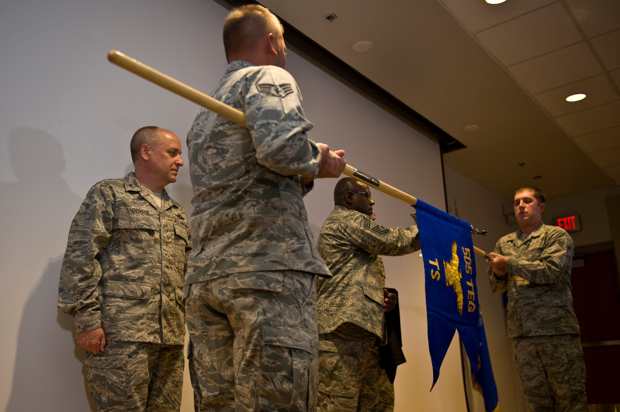 Chief Master Sgt. Garry Benton, center, 505th Test Squadron operations superintendent, cases the 505th Operations Squadron guidon, during a redesignation ceremony April 5 at Nellis Air Force Base, Nev. The 505th Operations Group and 505th Operations Squadron became the 505th Test and Evaluation Group and 505th Test Squadron during the ceremony. The units revised mission focus, to effectively test and integrate operational air, space and cyber command and control, or C2, domains, initiated the redesignation. Also pictured  are Col. Douglas Anderson, 505th TEG commander and members of the Nellis AFB Honor Guard. (U.S. Air Force photo/Airman 1st Class Daniel Hughes)