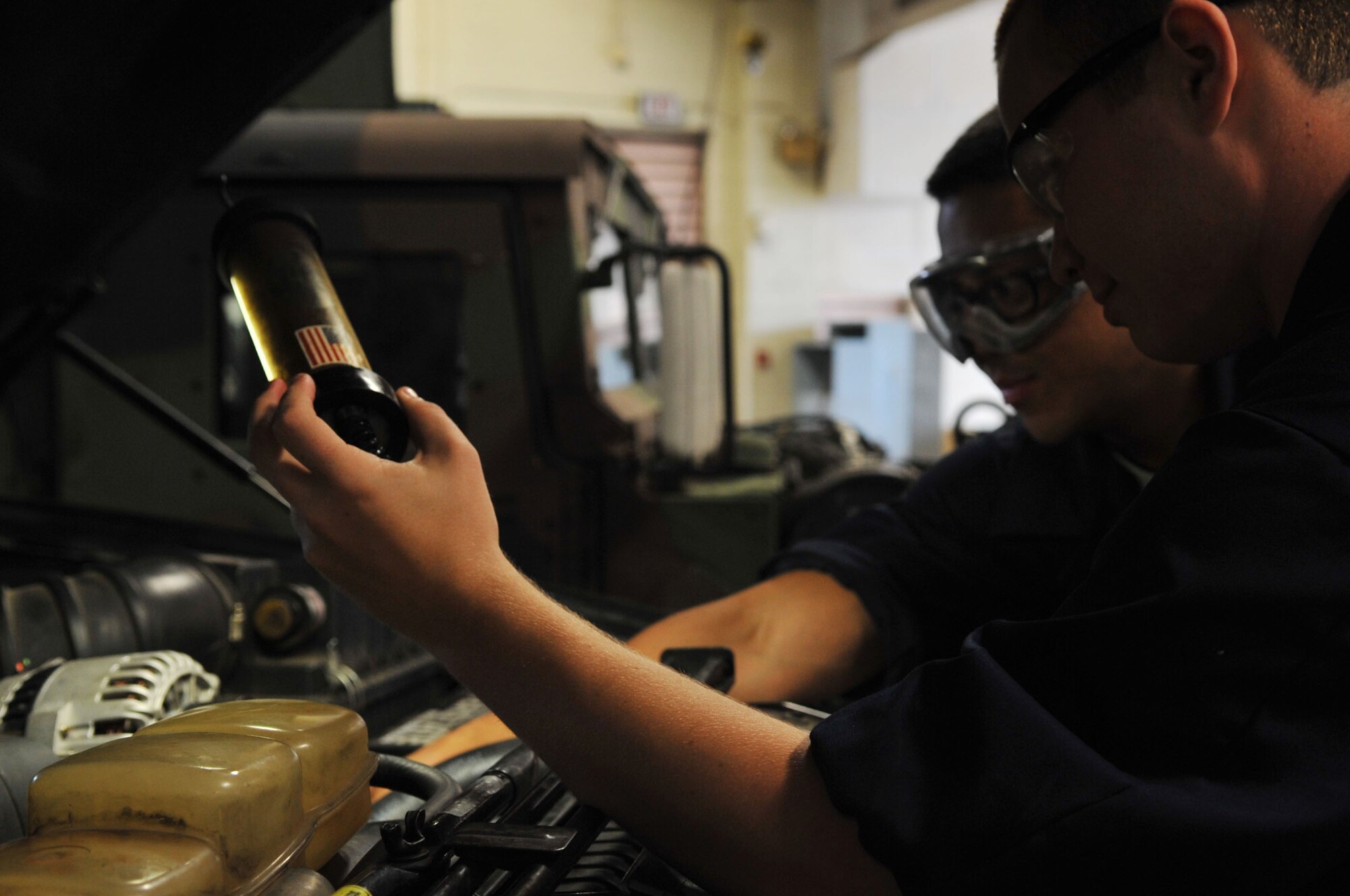 Airmen 1st Class Lloyd Bartolome and Justin Chapman, 2nd Logistics Readiness Squadron vehicle maintenance technicians, perform an overall inspection on a vehicle at Barksdale Air Force Base, La., April 7. An overall inspection consists of fluid, hose, corrosion and visual checks. The 2 LRS vehicle maintenance facility is responsible for more than 800 of Barksdale's government vehicles. (U.S. Air Force photo/Senior Airman Brittany Y. Bateman)(RELEASED)