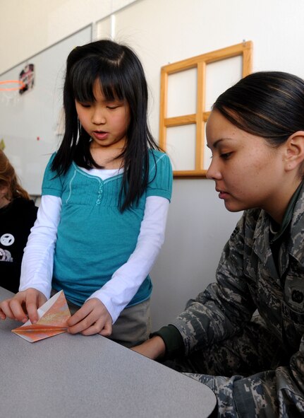 MISAWA AIR BASE, Japan-- Senior Airman Chelsea Cummings visits Cummings Elementary School on here and learns how to make an origami paper crane on April 2.  Cummings and Sollars Elementary Schools have collected more than 7,000 cranes to help reach the goal of 100,000 as part of an art display at a reconstructed school in Sendai, Japan. Students Rebuild is a global organization that mobilizes young people to connect, learn and take action on critical issues.  (U.S. Air Force Photo by Staff Sgt. April Quintanilla/Released)