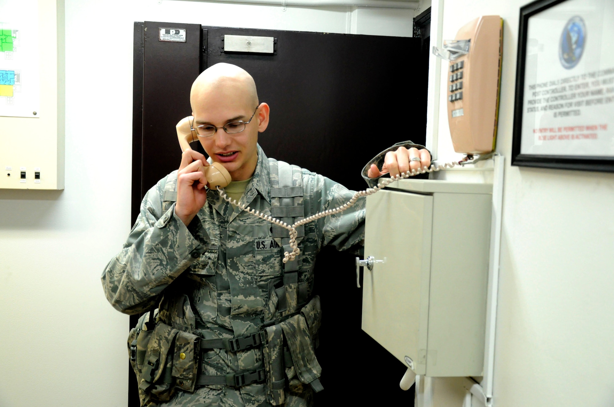 MISAWA AIR BASE, Japan--  Airman 1st Class David Chrisner, 35th Security Forces Squadron patrolman, makes a call while on watch at the base command post here April 8. Airman Chisner, a native of Moody, Texas, has been one of the many security forces Airmen helping Misawa Air Base during Operation Tomodachi. (U.S. Air Force photo by Senior Airman Joe W. McFadden/RELEASED)
