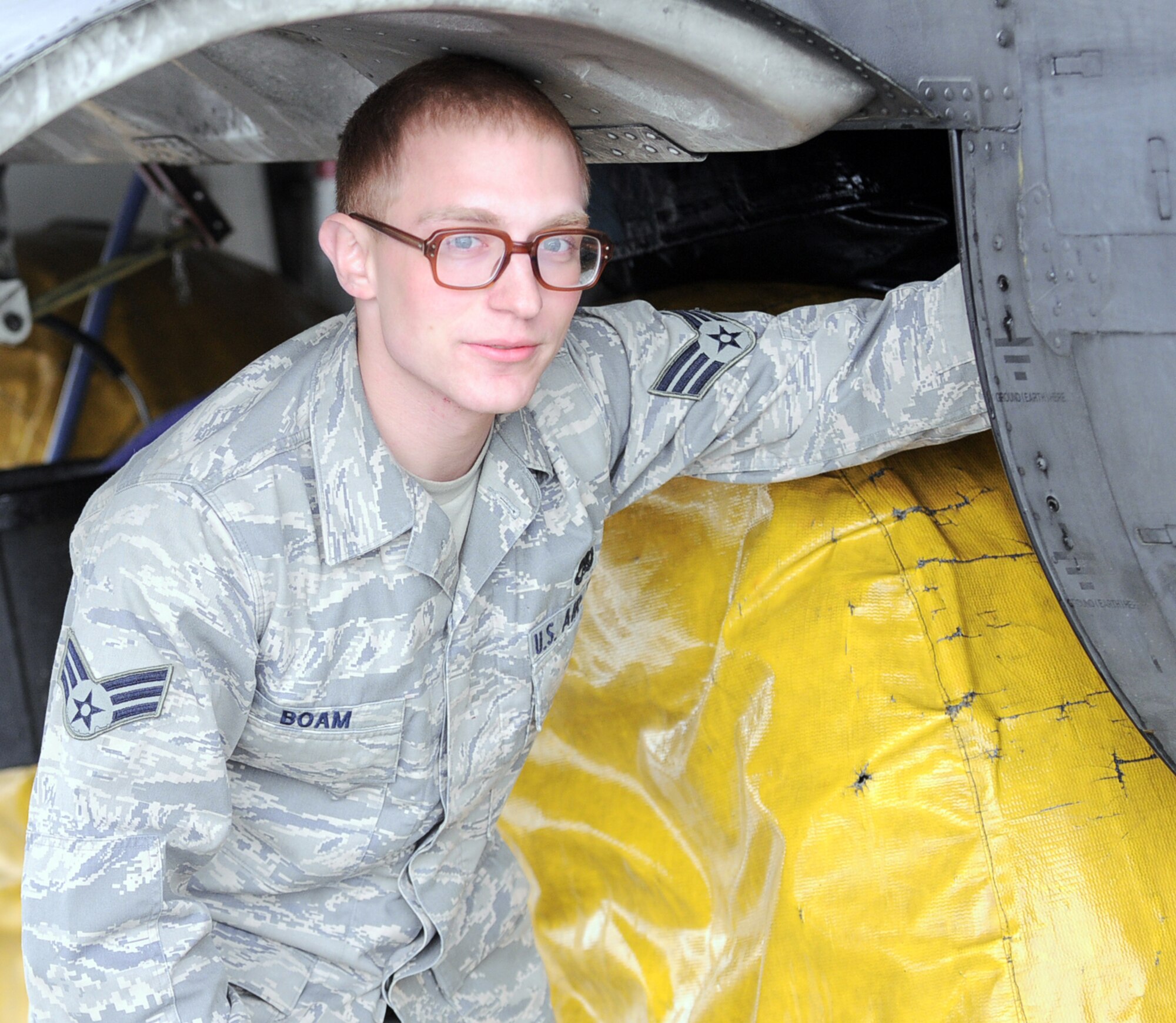 YOKOTA AIR BASE, Japan -- Senior Airman Jon-Cristofer Boam, 374th Maintenance Squadron, kneels under to a C-130 Hercules at Yokota Air Base, Japan, April 8, 2011. Airman Boam, a native of Erie, Penn., is currently deployed to Yokota in support of Operation Tomodachi. "This type of operation is important," said Airman Boam. "It feels great to know our efforts are going to a good cause."  (U.S. Air Force photo/Airman 1st Class Krystal M. Garrett)

