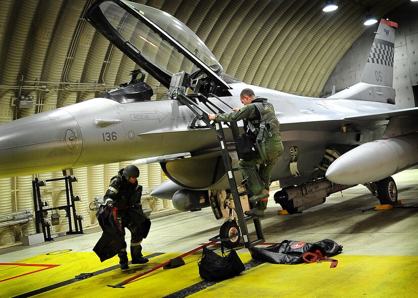51st Aircraft Maintenance Squadron Airmen prepare to work on an F-16 jet at Osan Air Base, Republic of Korea April 5 during the 2011 Korea Pacific Air Forces Command Operational Readiness Inspection. An ORI is conducted to evaluate and measure the ability of units with a wartime, contingency orforce sustainment mission to perform operations plan and assigned tasks. Inspectable areas include initial response, employment, mission support and Ability-to-Survive and Operate in a chemical environment. (U.S. Air Force photo/Senior Airman Evelyn Chavez)