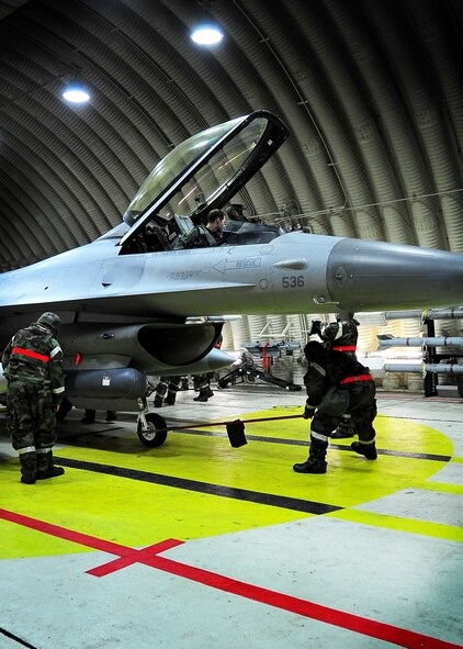 51st Aircraft Maintenance Squadron Airmen work on an F-16 jet at Osan Air Base, Republic of Korea April 5 during the 2011 Korea Pacific Air Forces Command Operational Readiness Inspection. An ORI is conducted to evaluate and measure the ability of units with a wartime, contingency orforce sustainment mission to perform operations plan and assigned tasks. Inspectable areas include initial response, employment, mission support and Ability-to-Survive and Operate in a chemical environment. (U.S. Air Force photo/Senior Airman Evelyn Chavez)