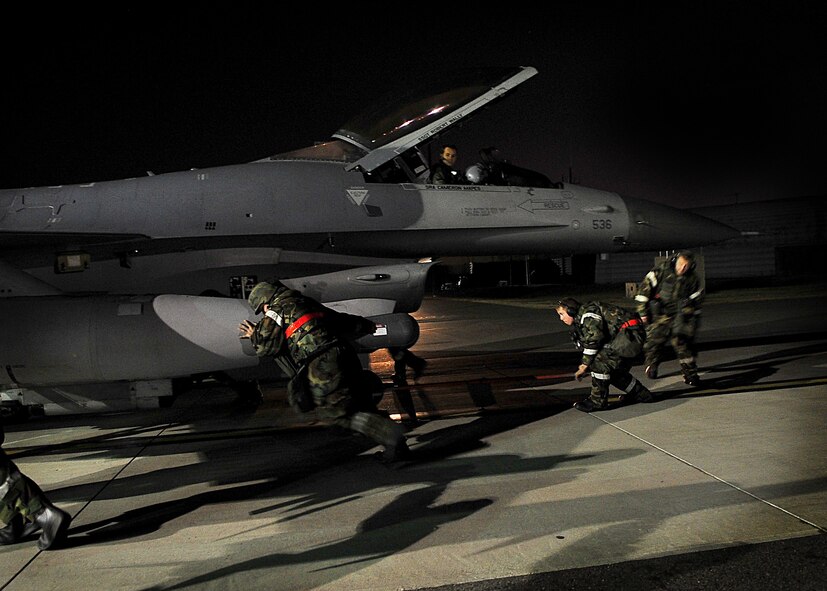 51st Aircraft Maintenance Squadron Airmen push an F-16 jet into a hangar at Osan Air Base, Republic of Korea April 5 during the 2011 Korea Pacific Air Forces Command Operational Readiness Inspection. An ORI is conducted to evaluate and measure the ability of units with a wartime, contingency orforce sustainment mission to perform operations plan and assigned tasks  Inspectable areas include initial response, employment, mission support and Ability-to-Survive and Operate in a chemical environment. (U.S. Air Force photo/Senior Airman Evelyn Chavez)