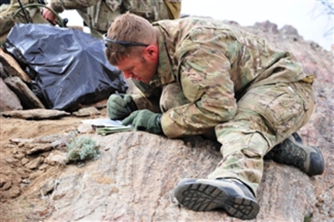 U.S. Air Force Tech. Sgt. Jonathan Oliver, a joint terminal attack controller assigned to the 817th Expeditionary Air Support Operations Squadron, reviews operation plans and maps on a remote mountaintop in Laghman province, Afghanistan, during Operation Bull Whip on March 27, 2011.  