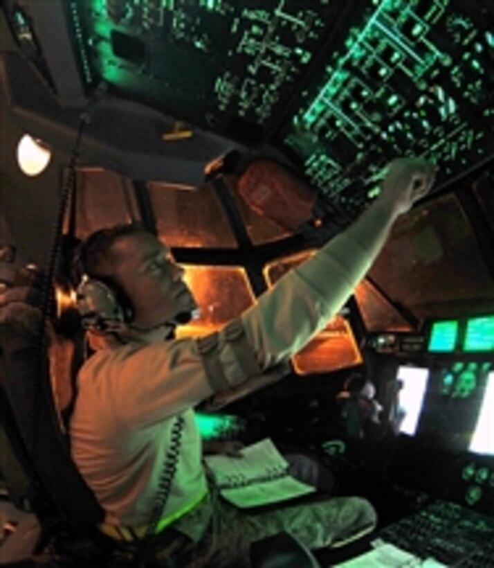 Staff Sgt. Troy Miller checks fuel tank levels from the flight deck of a C-130 Hercules aircraft at Little Rock Air Force Base, Ark., on March 24, 2011.  Miller is a panel operator assigned to the 19th Component Maintenance Squadron.  