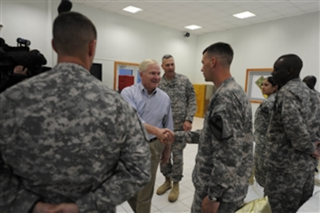 Secretary of Defense Robert M. Gates talks with soldiers and airmen from the 4/1 Advise and Assist Brigade during a trip in Mosul, Iraq, on April 8, 2011.  Gates met with U.S. and Iraqi leaders, troops and held discussions while taking photos and giving out coins to deployed members during his stay in Iraq.  