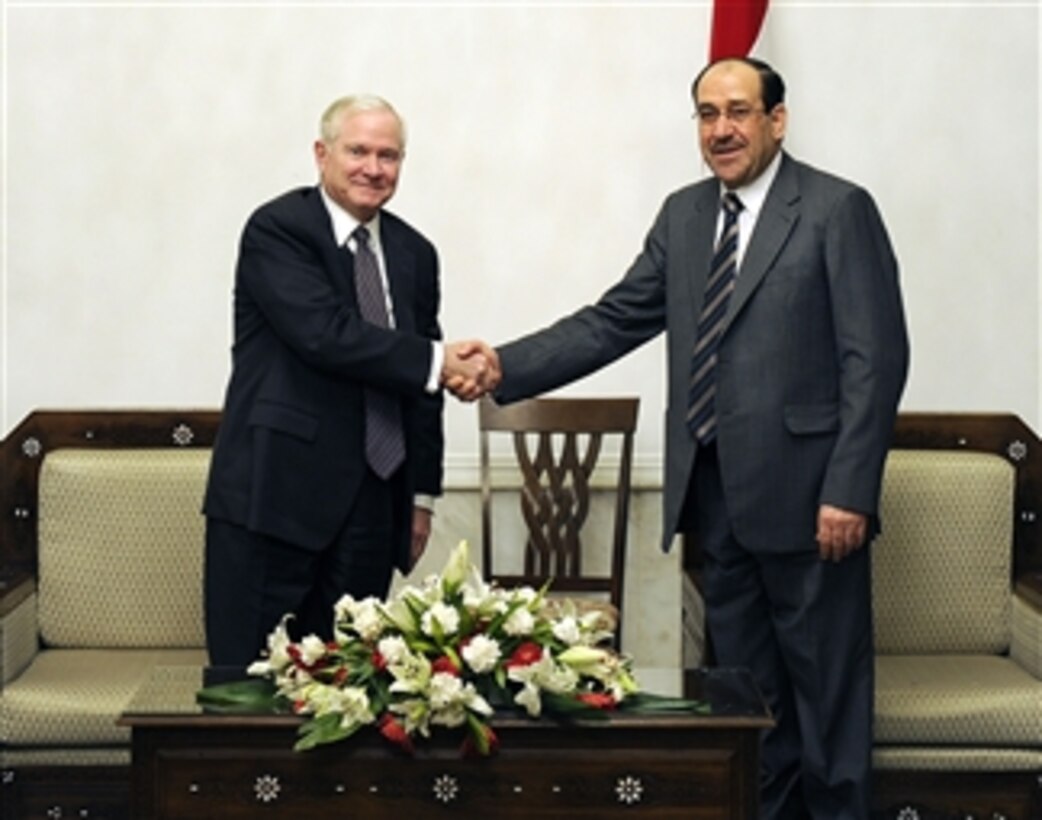 Secretary of Defense Robert M. Gates poses for a photo and shakes hands with Iraqi Prime Minister Maliki during a trip to Baghdad, Iraq, on April 7, 2011.  Gates also met with troops and held discussions while taking photos and giving out coins to deployed members.  