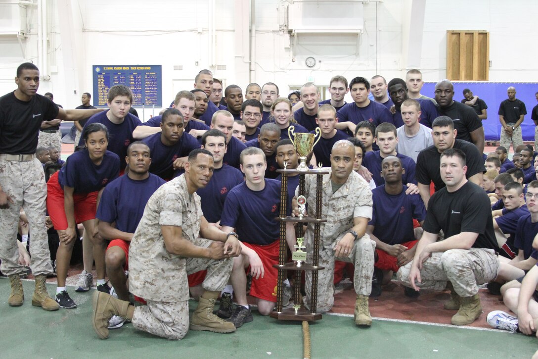 Major David C. Hyman, commanding officer, and Sgt. Maj. Brian Taylor, Recruiting Station Baltimore, present a trophy to the recruiters and poolees of recruiting sub-station Columbia for their victory in the RS’s annual poolee field meet April 9. Columbia defeated 10 other RSS’s to claim the trophy and bragging rights until next year’s field meet.