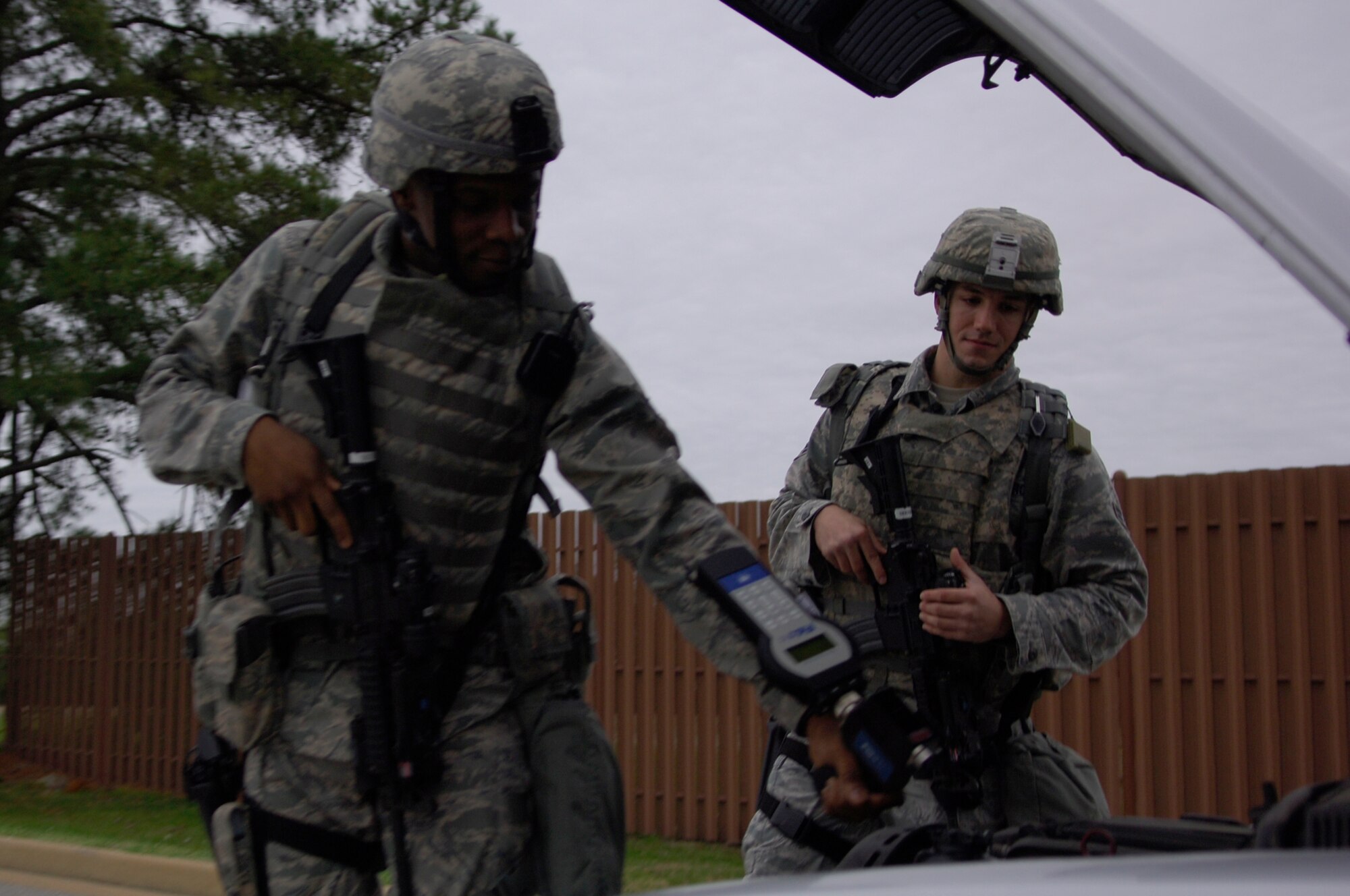 Airmen 1st Class Matthew Fields and David Rogers, 633d Security Forces Squadron Vehicle Search Unit, inspect a vehicle during an Operational Readiness Inspection at Langley Air Force Base Va., April 9, 2011. An ORI is conducted to evaluate and measure a unit’s  wartime, contingency and force sustainment mission as well as its ability to perform operation plans and assigned tasks. (U.S. Air Force photo by Airman 1st Class Camilla Elizeu/Released)  