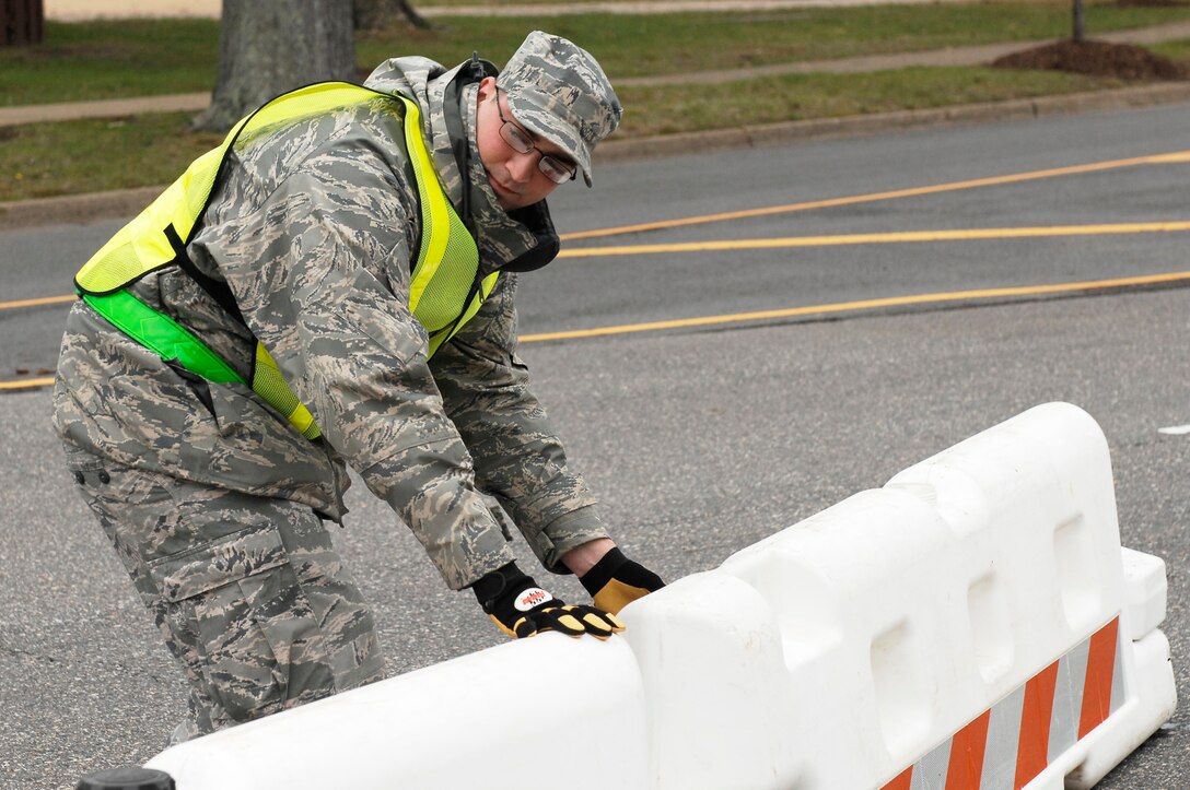 Staff Sgt. Andrew Labrake, 633d Civil Engineer Squadron heating ventilation and air conditioning technician, implements security measures during an Operational Readiness Inspection at Langley Air Force Base, Va., April 9, 2011. The ORI is designed to evaluate the rapid deployment capability of installation personnel, cargo, and equipment. (U.S. Air Force photo by Airman 1st Class Kayla Newman/Released)