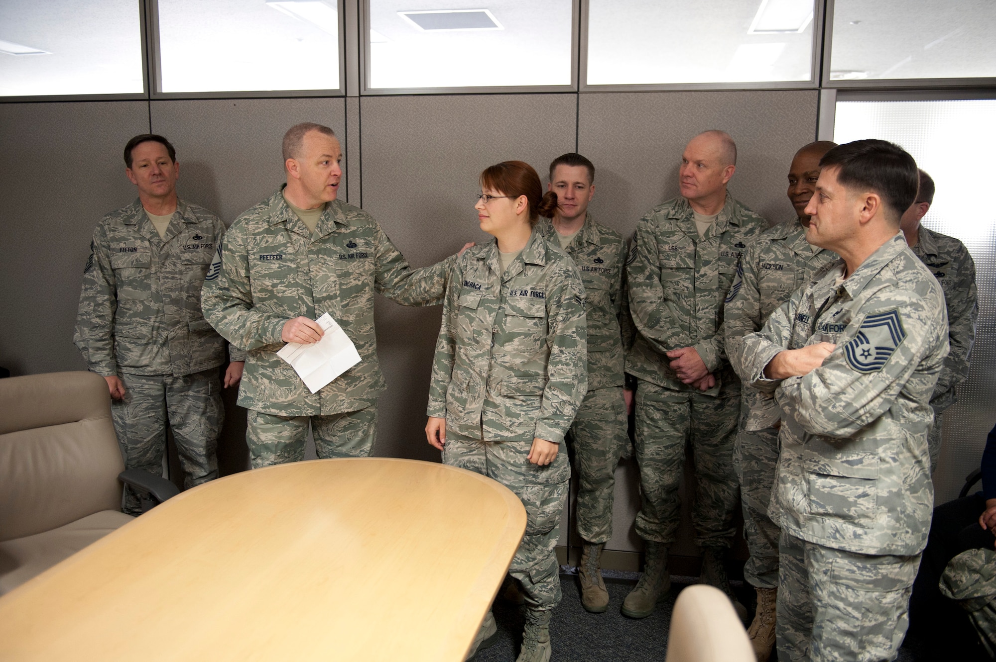 YOKOTA AIR BASE, Japan -- Chief Master Sgt. Thomas Pfeffer, Yokota Chiefs' Group, declares Airman 1st Class Katrina Menchaca the first recipient of the Yokota Chiefs' Group "sharp troop" award at the 374th Airlift Wing headquarters building, Yokota Air Base, Japan, April 7, 2011. Airman Menchaca is a journalist for the public affairs office, documenting and telling the story of Operation Tomodachi. (U.S. Air Force photo/Staff Sgt. Samuel Morse)
