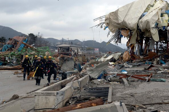 Members of the Los Angeles County Urban Search and Rescue Team, Task Force 2, move to another location on their search grid through the tsunami-ravished streets of Japan.  They travelled with the 452nd Air Mobility Wing, March Air Reserve Base, Calif., to the earthquake and tsunami stricken areas of Japan just four days after the devastation.  (U.S. Air Force photo/Technical Sgt. Daniel St. Pierre)