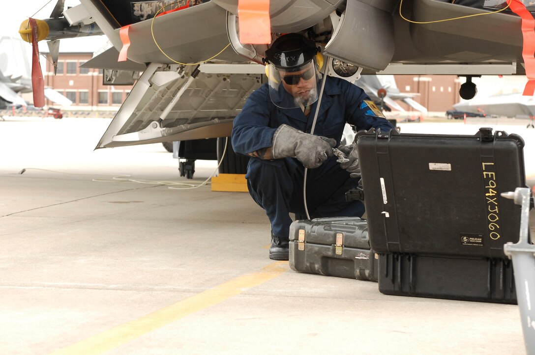 Senior Airman DeAndre Barnes, 27th Aircraft Maintenance Unit crew chief, services the stored energy system of an F-22 Raptor during an Operational Readiness Inspection at Langley Air Force Base, Va., April 9, 2011. The ORI is designed to evaluate the rapid deployment capability of installation personnel, cargo and, equipment. (U.S. Air Force photo by Airman 1st Class Kayla Newman/Released)
