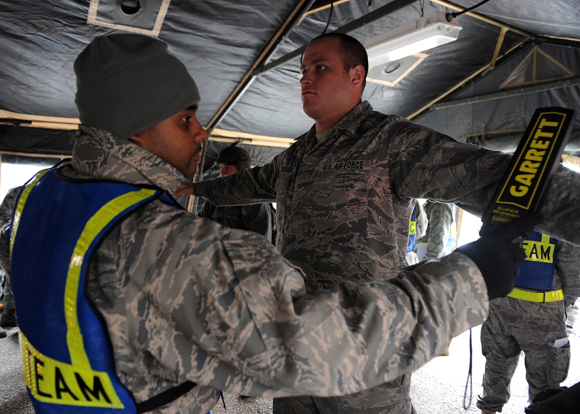 Senior Airman Daniel Jones, 633d Force Support Squadron services technician, scans Staff Sgt. Brian Stevenson, 27th Fighter Squadron avionics specialist, for metal during the Operational Readiness Inspection at Langley Air Force Base, Va., April 9, 2011. The inspection is designed to evaluate the ability of installation personnel to efficiently deploy military members, cargo and equipment while also adjusting to rapidly changing security conditions.(U.S. Air Force photo/Senior Airman Zachary Wolf)