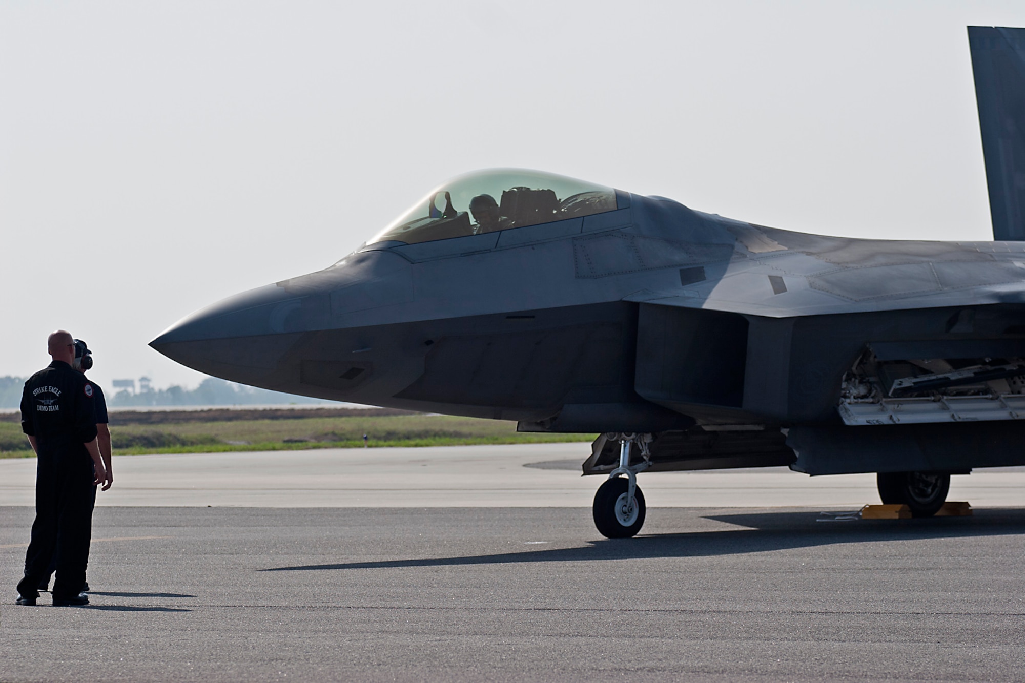 An F-22 pilot parks his Raptor just feet away from spectators at  Charleston Air Expo 2011 April 9, 2011 at Joint Base Charleston, S.C. The stealth fighter also performed several flyby passes over the crowd while demonstrating the aircraft's finesse and relatively quiet engines. (U.S. Air Force Photo by Michael Dukes)
