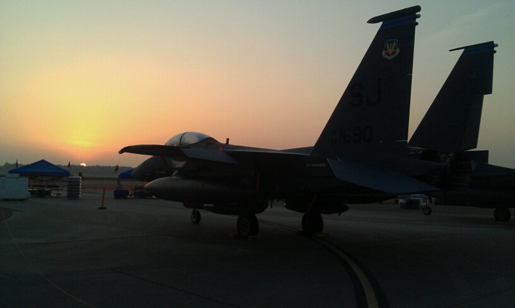 An F-15E sits on the flight line while the sun rises at the Charleston Air Expo 2011 at Joint Base Charleston, S.C. in the early the morning of April 9, 2011.  (U.S. Air Force photo by Michael Dukes)