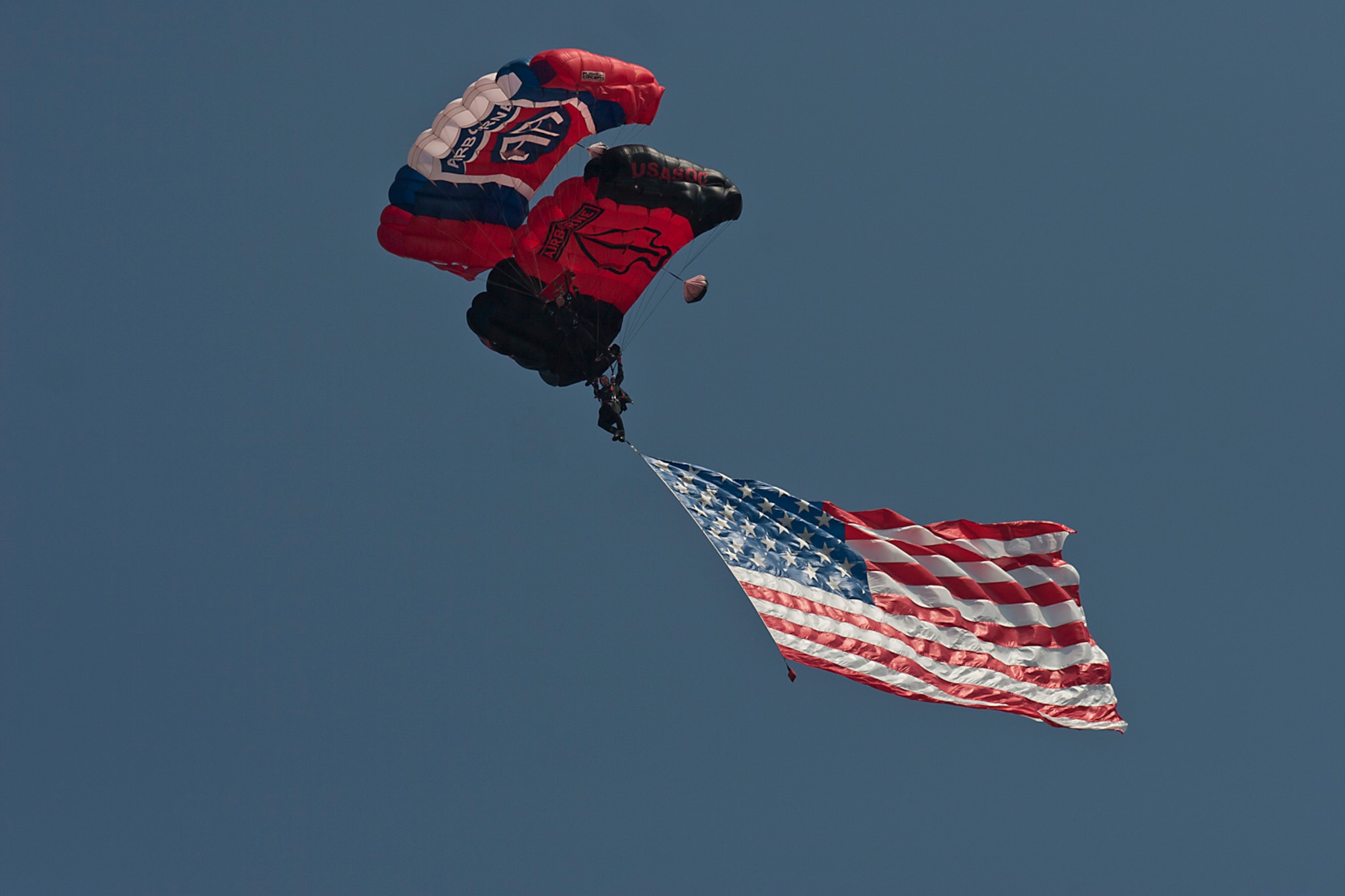 The Black Daggers U.S. Army Special Operations Command Parachute Demo Team  Drops from a C-17 Globemaster III with the U.S. Flag above nearly 100,000 spectators during the opening of the Charleston Air Expo 2011 at Joint Base Charleston April 9, 2011. (U.S. Air Force photo by Michael Dukes)