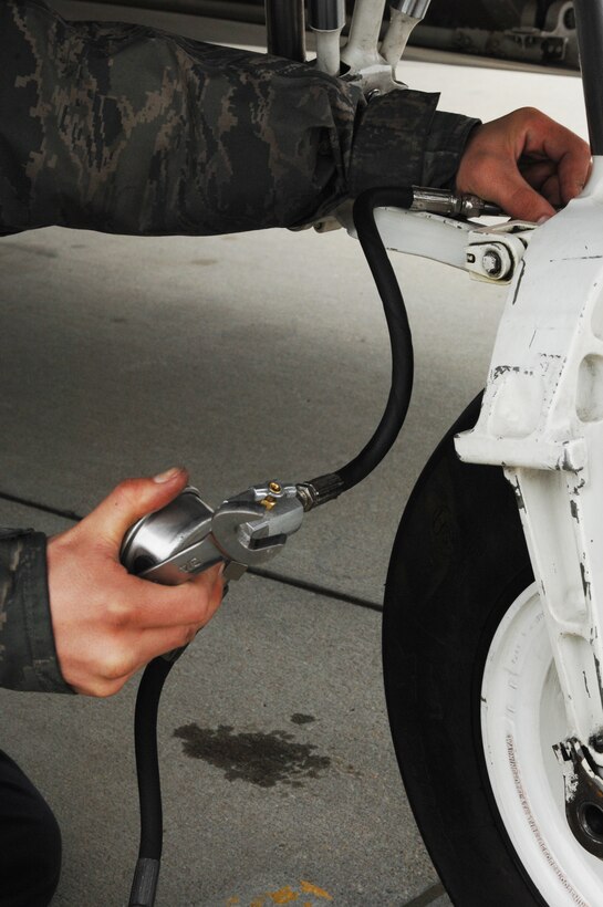 Airman 1st Class Philip Popovich, 94th Maintenance Squadron crew chief, checks the tire pressure of an F-22 Raptor during an Operational Readiness Inspection at Langley Air Force Base, Va., April 9, 2011. The inspection evaluates an installation's ability to efficiently deploy military members and rapidly adjust to changing security conditions. (U.S. Air Force Photo/Airman 1st Class Teresa Zimmerman/Released)