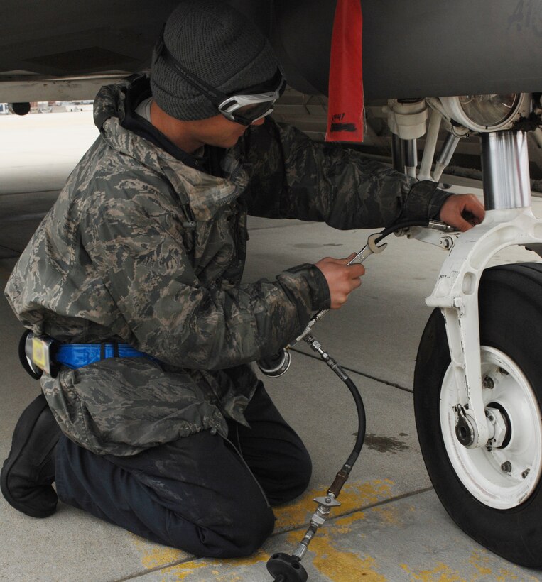 Airman 1st Class Philip Popovich, 94th Maintenance Squadron crew chief, checks the tire pressure of an F-22 Raptor during an Operational Readiness Inspection at Langley Air Force Base, Va., April 9, 2011. The inspection evaluates an installation's ability to efficiently deploy military members and rapidly adjust to changing security conditions. (U.S. Air Force Photo/Airman 1st Class Teresa Zimmerman/Released)