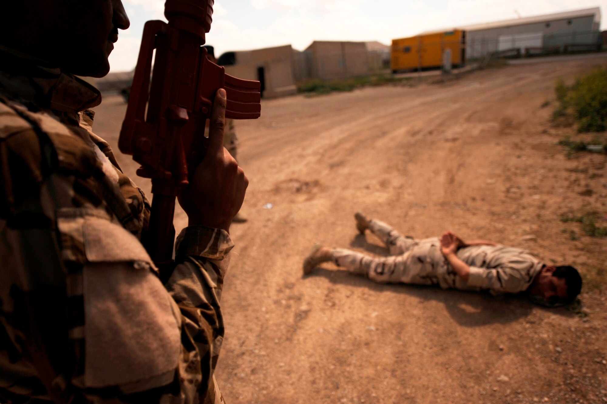 KIRKUK REGIONAL AIR BASE, Iraq -- An Iraqi air force defender detains a simulated suspect during a practical evaluation by Iraq Training and Advisory Mission-Air advisors April 6. More than a dozen Iraqi defenders graduated April 7 from a two-week security forces course taught by U.S. Air Force Airmen. Since January, ITAM-Air security forces advisors have trained more than 50 Iraqi airmen at four bases nationwide. (U.S. Air Force/Tech. Sgt. Jason Lake)
