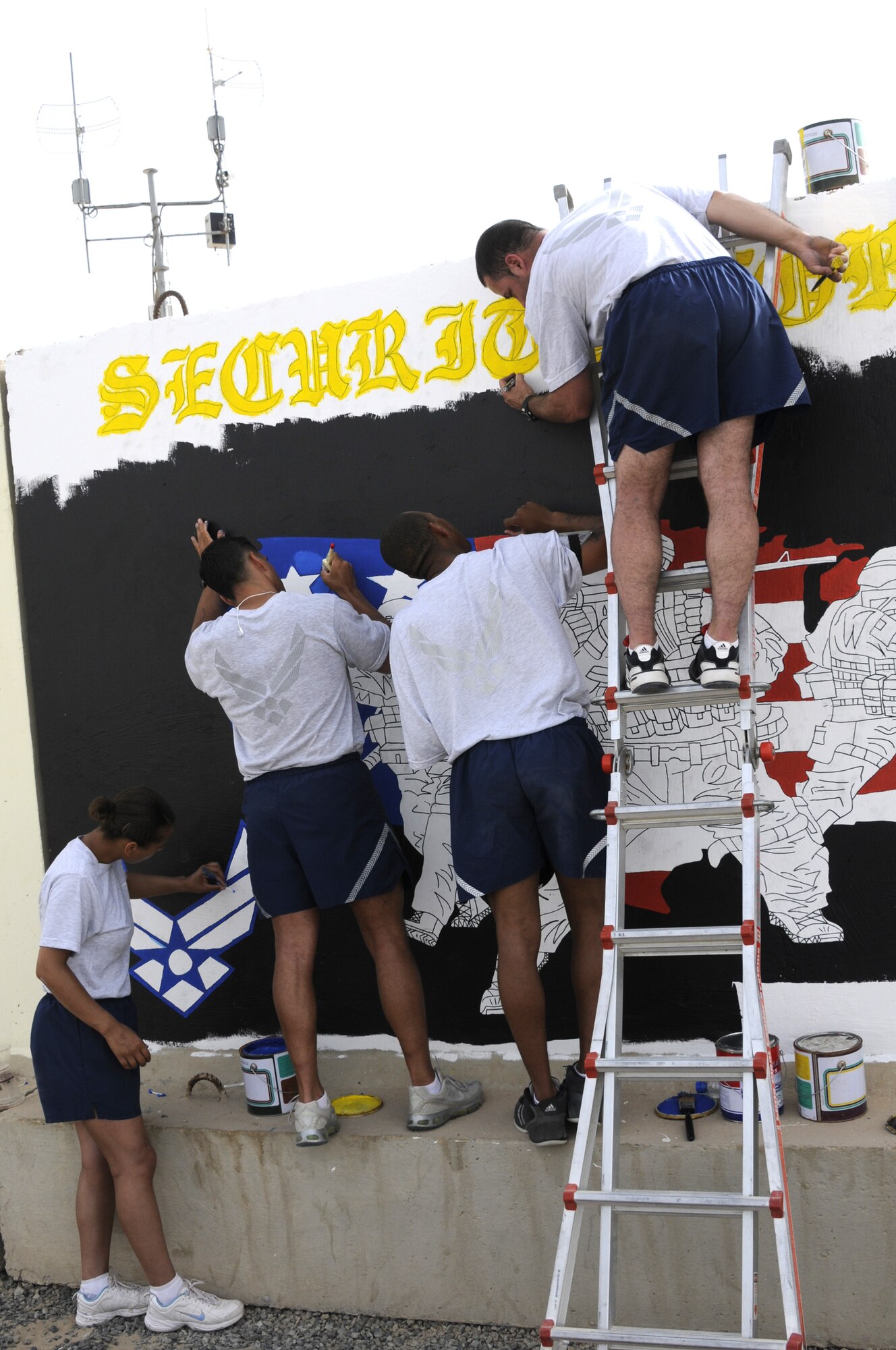 From left: Senior Airman Angela Christiansen, Staff Sgt. Joe Roman, Airman 1st Class Ryan Rucker and Senior Airman Isac Ramos. The group is painting a mural at the 386th Air Expeditionary Wing April 7. They are all members of the 386th Expeditionary Security Forces Squadron deployed to Southwest Asia from the 514th Security Forces Squadron, which is an Air Force Reserve unit located at McGuire Air Force Base, N.J. (U.S. Air Force photo by Capt. Heath Allen)
