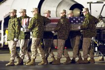 A U.S. Marine Corps carry team transfers the remains of Marine Staff Sgt. Jason A. Rogers, of Jackson, Miss., at Dover Air Force Base, Del., April 8, 2011. Rogers was assigned to the 2nd Combat Engineer Battalion, 2nd Marine Division, II Marine Expeditionary Force, Camp Lejeune, N.C. (U.S. Air Force photo/Roland Balik)