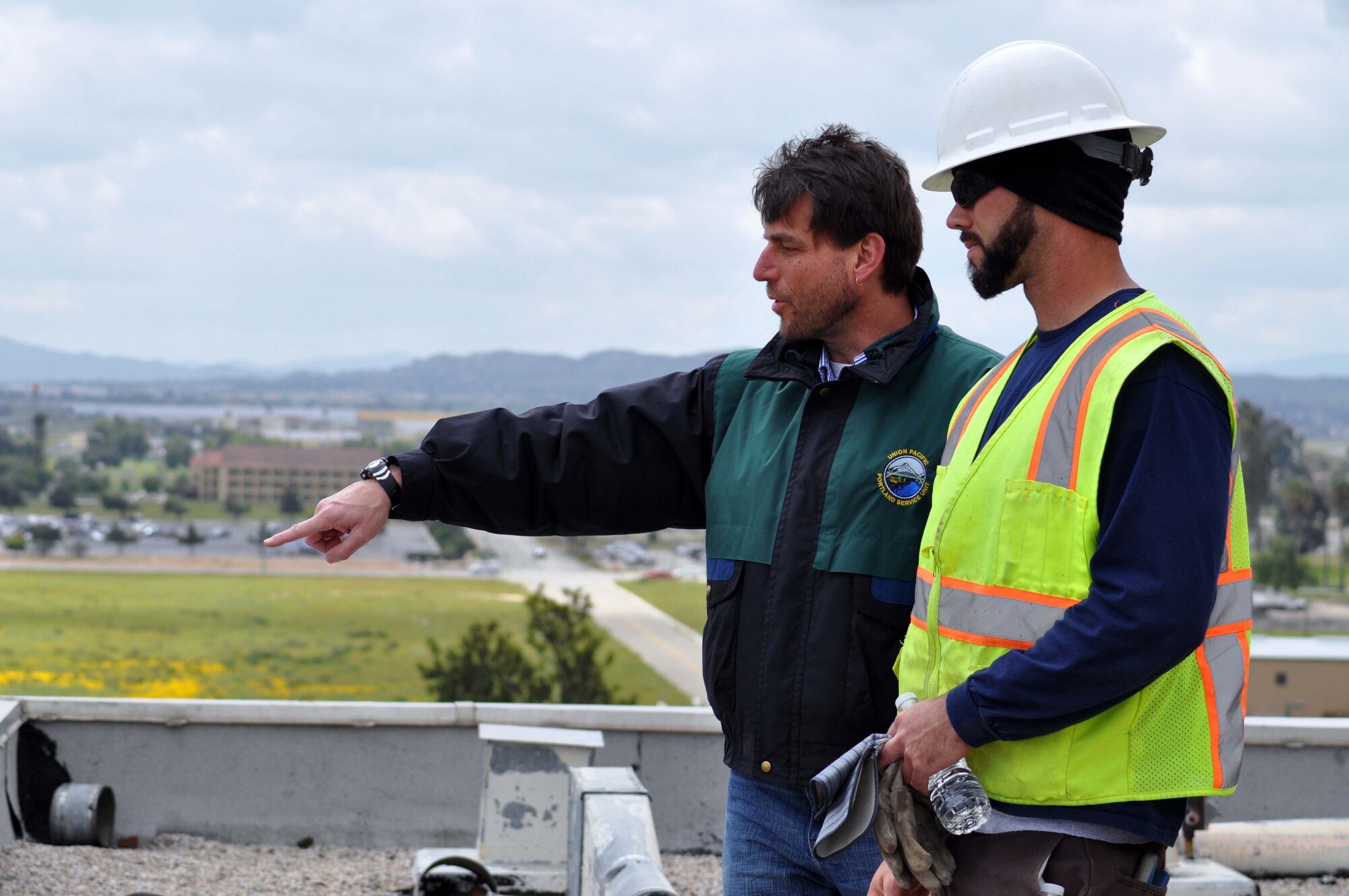 Darren Hughes points out recognizable landmarks to Ryan Morin of U.S. Demolition during a visit to the former March Air Force Base hospital building March 27, 2011, just four days before it is scheduled for demolition to make way for March LifeCare medical facilities.  Huges is a former employee of the hospital and recalled watching airshow practices from the roof.  (U.S. Air Force photo/Linda Welz)
