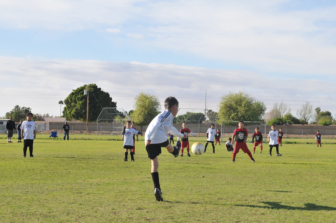 Alec Bailey, soccer player for the Yuma Dragons, kicks the ball downfield during an April 9, 2011, game at Rancho Viejo Elementary School in Yuma, Ariz. Bailey and his teammates are coached by Sgt. Rodolfo Ayala, Combat Logistics Company 16 utility chief, who has been part of the All-Marine men's soccer team two years in a row.