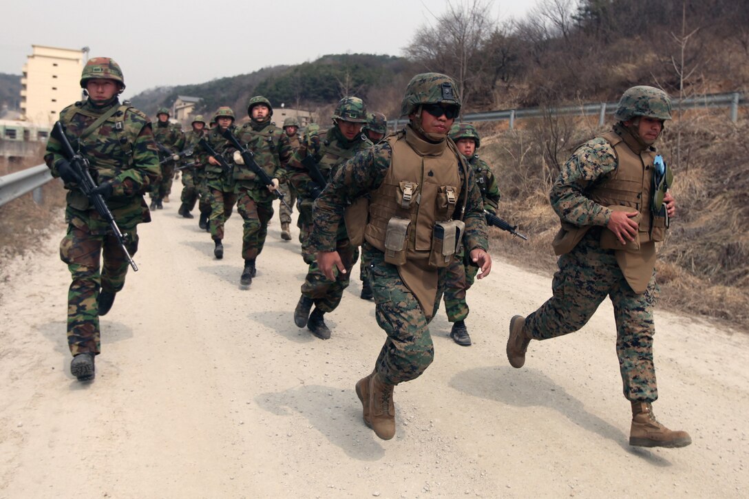 Republic of Korea and U.S. Marines jog to the outskirts of town after completing a challenging obstacle course during a final evaluation of their knowledge of Military Operations in Urban Terrain during the the Korean Incremental Training Program Exercise 2011-1 at Camp Rodriguez, Republic of Korea, April 10. KITP 11 runs from April 2 to May 8 and is designed to strengthen the ROK-U.S. Alliance and operational readiness, while promoting stability throughout the Korean Peninsula.