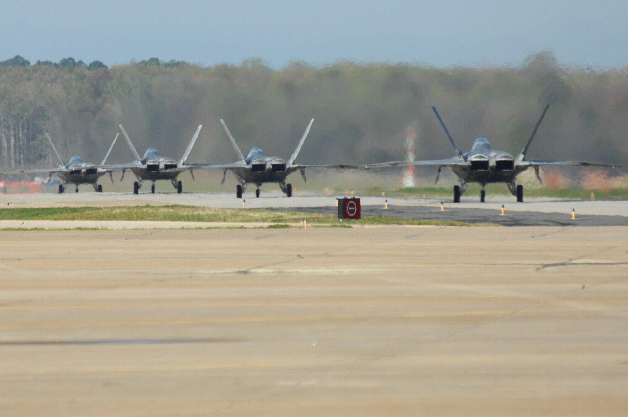 F-22 Raptors taxi the runway during an Operational Readiness Inspection at Langley Air Force Base, Va., April 10, 2011. The inspection is a two-day evaluation of how quickly and efficiently the 633d Air Base Wing, 1st Fighter Wing and 192 FW can deploy people, equipment and aircraft while adjusting to rapidly changing security conditions. (U.S. Air Force Photo/Airman 1st Class Teresa Zimmerman/Released)