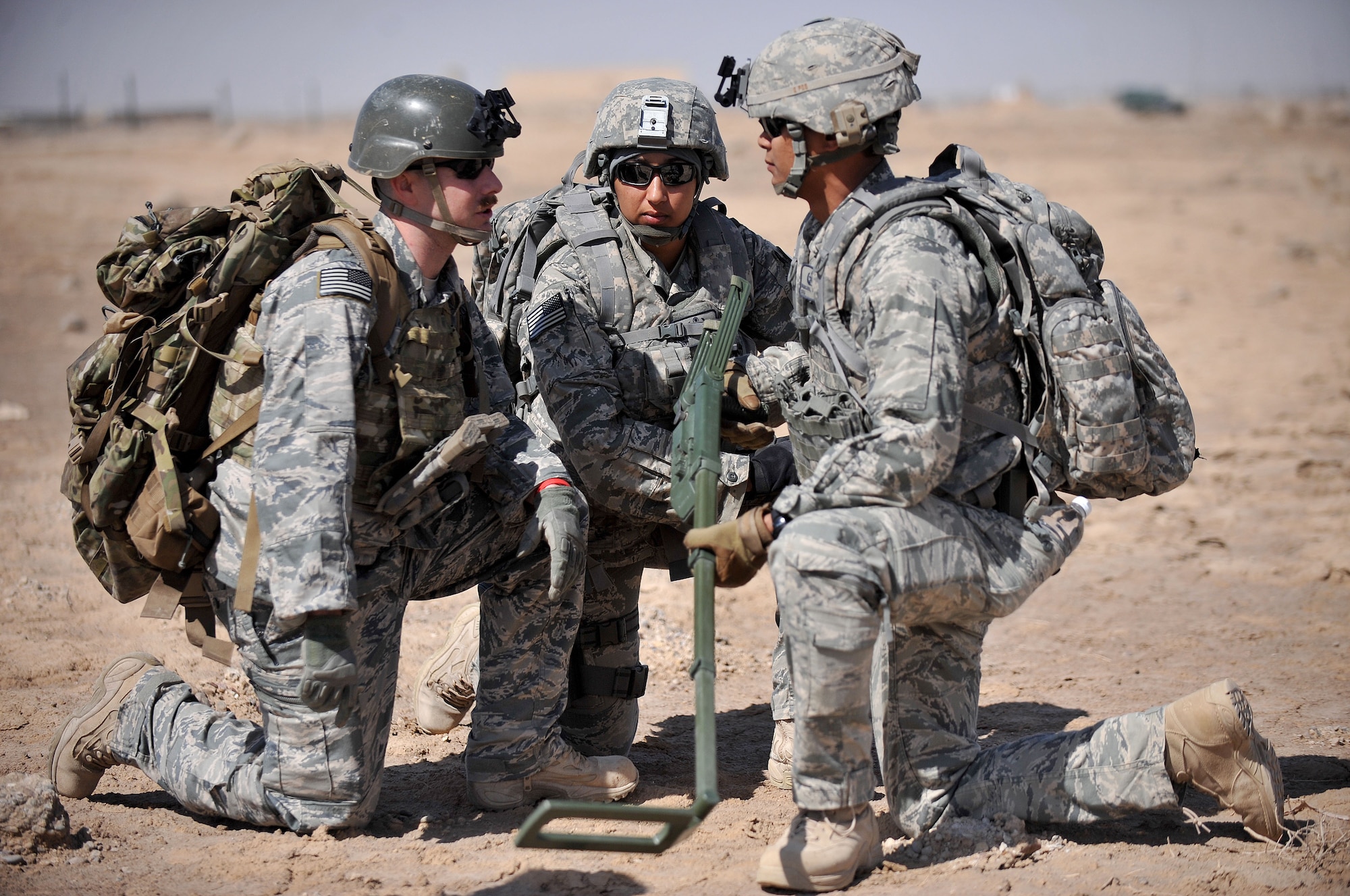 The 407th Expeditionary Operations Support Squadron explosive ordnance disposal team talks together about the scenario at hand during a training exercise March 3, 2010, at Ali Air Base, Iraq. (U.S. Air Force photo by Senior Airman Andrew Lee/Released) 