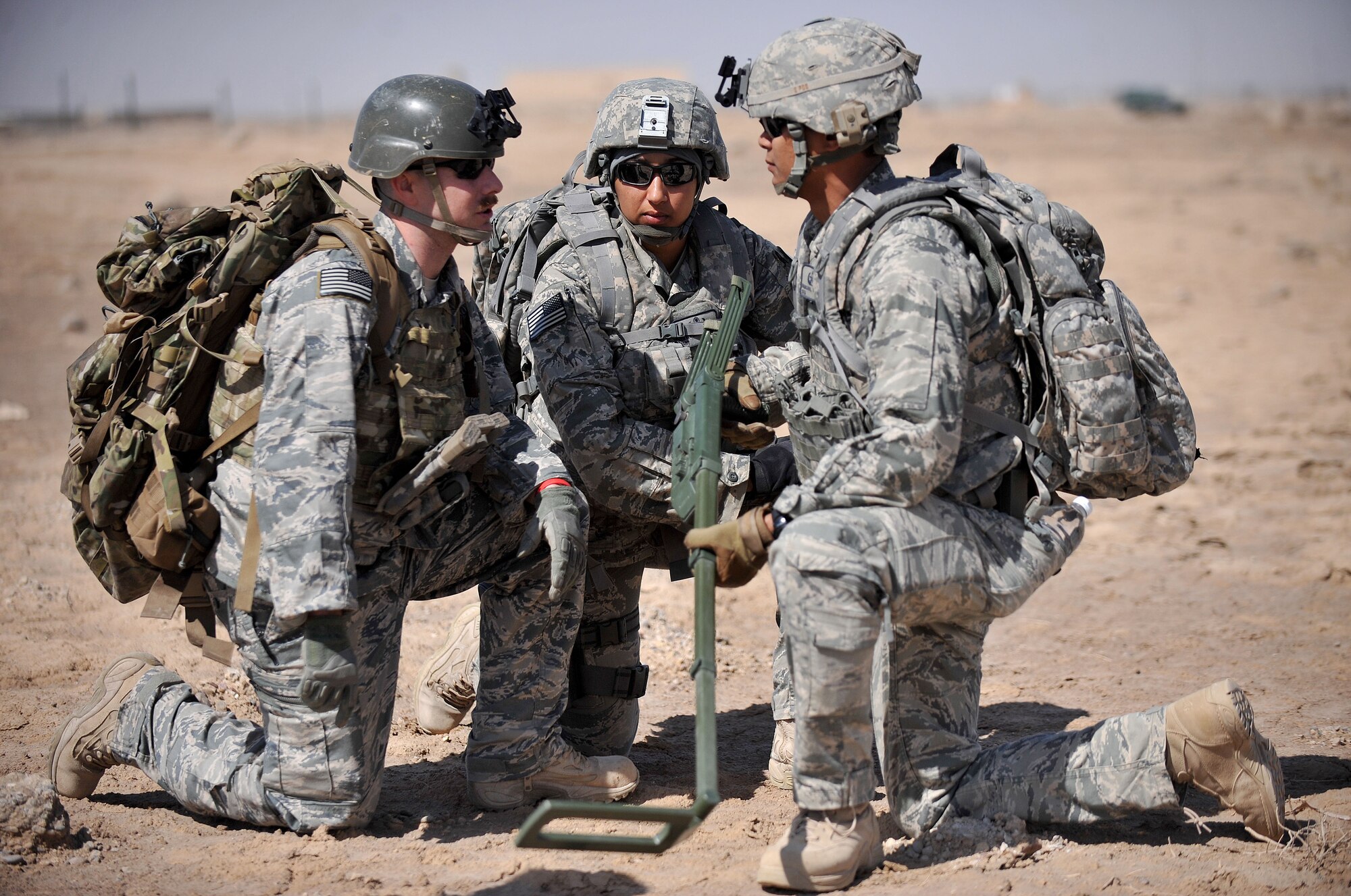 The 407th Expeditionary Operations Support Squadron explosive ordnance disposal team talks together about the scenario at hand during a training exercise March 3, 2010, at Ali Air Base, Iraq. (U.S. Air Force photo by Senior Airman Andrew Lee/Released) 