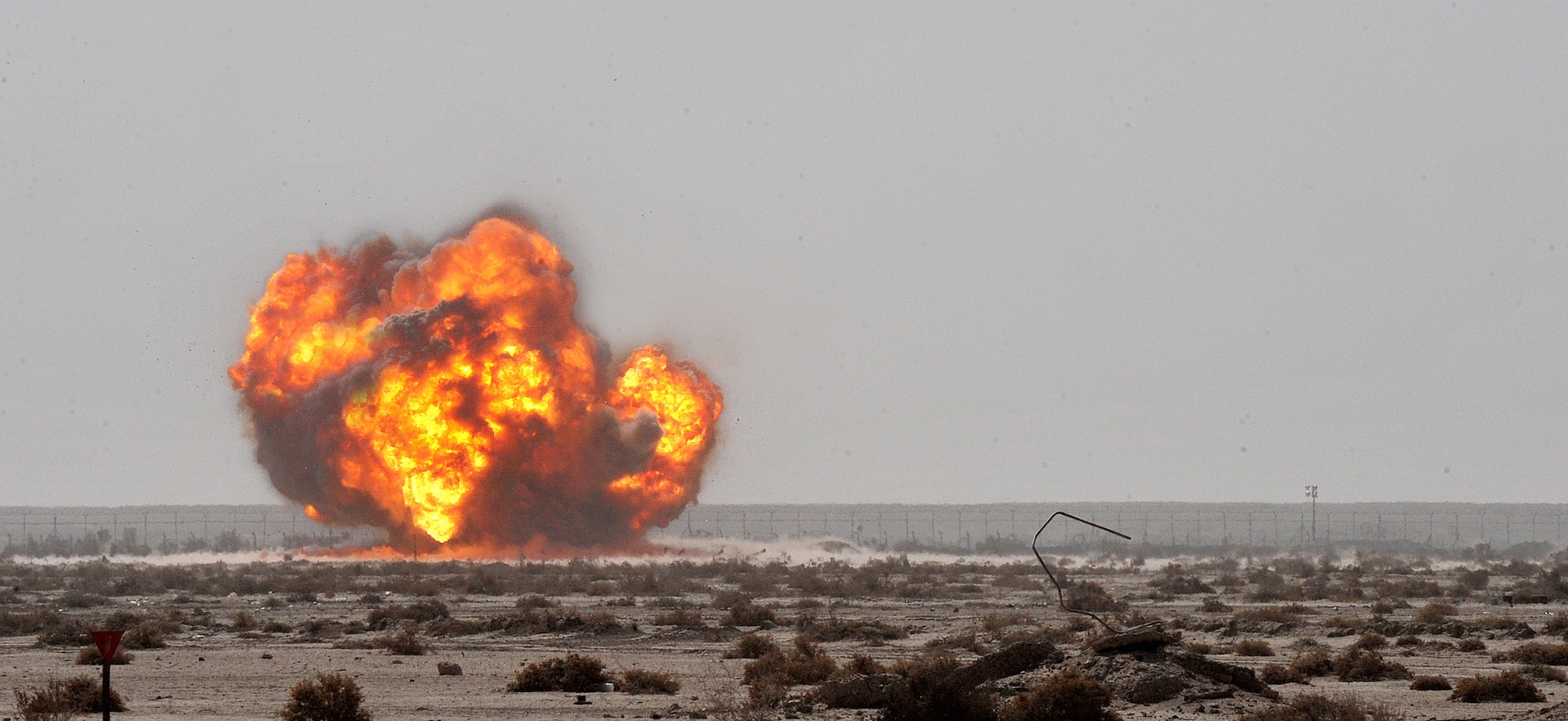 The 407th Expeditionary Operations Support Squadron explosive ordnance disposal team along with an U.S. Army EOD team successfully detonates a pile of 40 millimeter rounds and C-4 March 3, 2010, at Ali Air Base, Iraq.  (U.S. Air Force photo by Senior Airman Andrew Lee/Released)