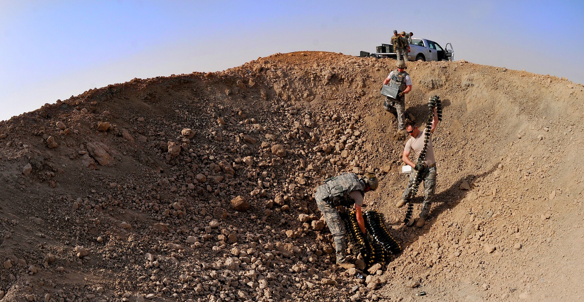 The 407th Expeditionary Operations Support Squadron explosive ordnance disposal team along with an U.S. Army EOD team, pile up 40 millimeter rounds and C-4 for a detonation March 3, 2010, at Ali Air Base, Iraq.  (U.S. Air Force photo by Senior Airman Andrew Lee/Released)