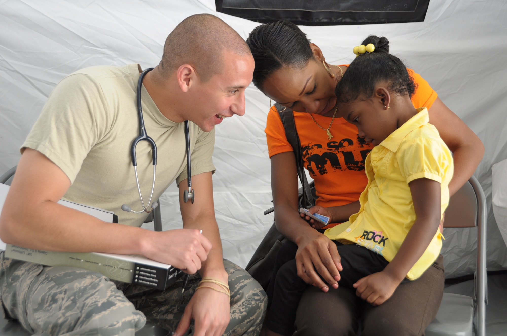 U.S. Air Force Capt. Brian Montenegro, 60th Medical Group Pediatrician, talks to Gabriella Alexander, 3, at Cumuto Barracks in Trinidad and Tobago April 9, 2011. Montenegro is a part of the Expeditionary Medical Support Health Response Team in support of the Allied Forces Humanitarian Exercise/Fuerzas Aliadas or FA HUM 2011. (U.S. Air Force photo by 2d Lt Joel Banjo-Johnson/Released)