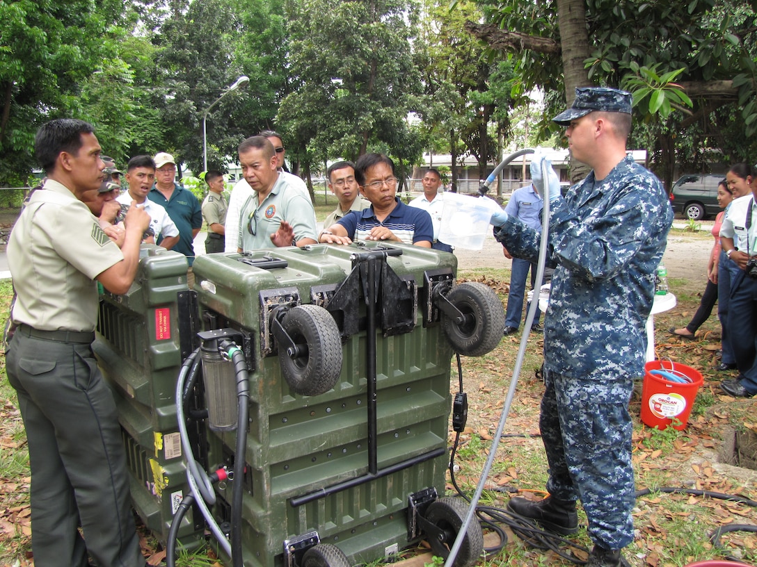 Personnel from the U.S. Marine Corps Forces Pacific Experimentation Center train service members from the armed forces of the Philippines’ National Development Support Command on the operation of the Aspen 2000DM water purification system during exercise Balikatan 2011, held from March to April, at Camp Aguinaldo, Quezon City, Philippines.