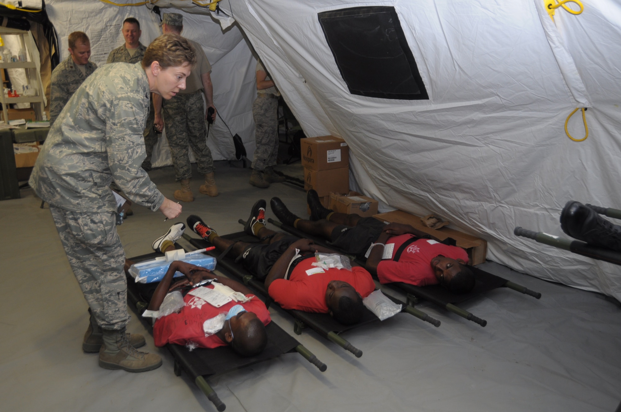 U.S. Air Force Col. Mary Brueggemeyer, 60th Aerospace Medicine squadron commander and flight surgeon in the exercise, talks to three role players at Cumuto Barracks in Trinidad and Tobago April 11, 2011.  Colonel Brueggemeyer is a part of an expeditionary medical support health response team in support of the Allied Forces Humanitarian Exercise or Fuerzas Alidas Humanitarias 2011. (U.S. Air Force Photo/2nd Lt Joel Banjo-Johnson)
