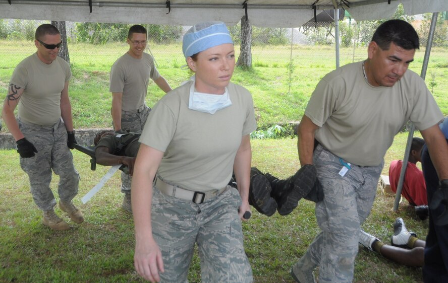 U.S. Air Force Staff Sgt. Conan Broyles, 60th Medical Group medical technician, Staff Sgt John Kuliczkowski, 818th Global Support Squadron, Staff Sgt. Jamie Dillon, 60th MDG dental technician and Master Sgt. Jesse Moreno, AFSOUTH international health specialist carry a man to the facility at Cumuto Barracks in Trinidad and Tobago April 11, 2011.  The medical team make up some of the members of an expeditionary medical support health response team in support of the Allied Forces Humanitarian Exercise or Fuerzas Alidas Humanitarias 2011. (U.S. Air Force Photo/2nd Lt Joel Banjo-Johnson)
