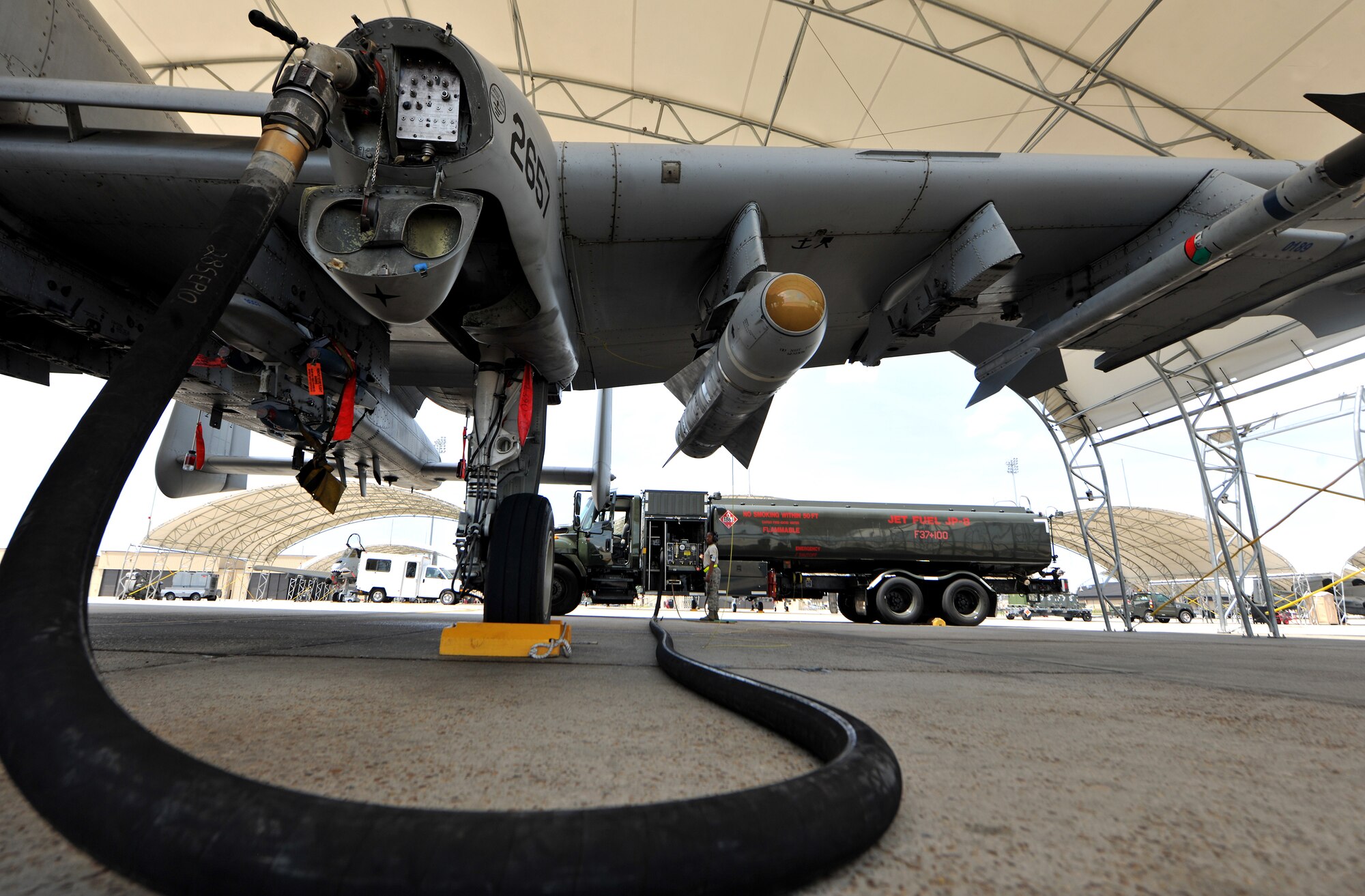 An A-10C Thunderbolt II is refueled on the flightline during a refueling session at Moody Air Force base, Ga.  April 11. Each fuel truck holds 6,000 gallons of fuel and refuels aircraft an estimated 48 times on a busy day. (U.S. Air Force photo/Airman 1st Class Joshua Green)
