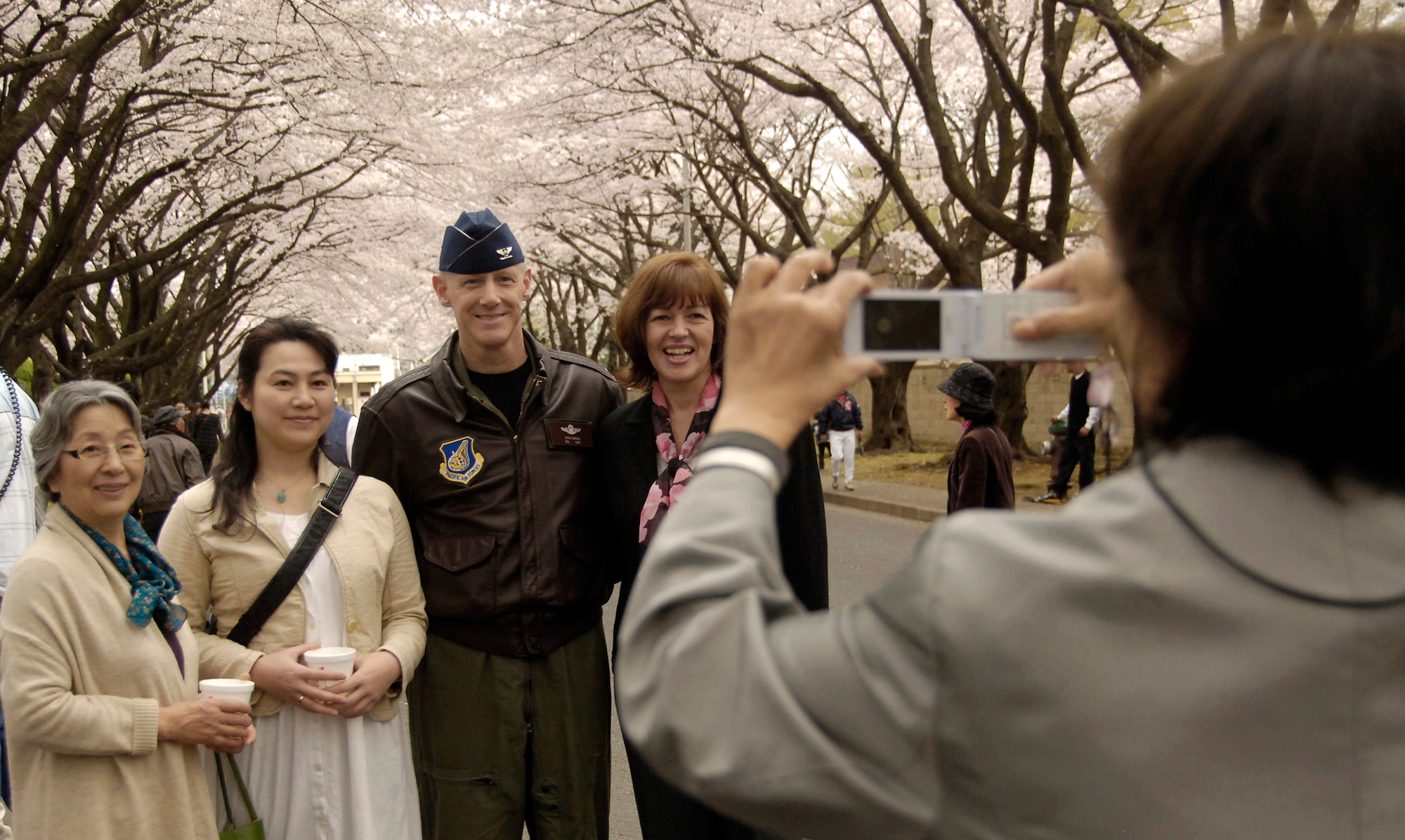 Col. Otto Feather and his wife, Nancy, pause for a picture with a Japanese family April 10, 2011 at the Cherry Blossom Open House at Yokota Air Base, Japan. Base officials opened the gates to the public, allowing the local Japanese community to come on to Yokota to see the trees in full bloom. Colonel Feather is the 374th Airlift Wing commander. (U.S. Air Force photo/Staff Sgt. J.G. Buzanowski) 