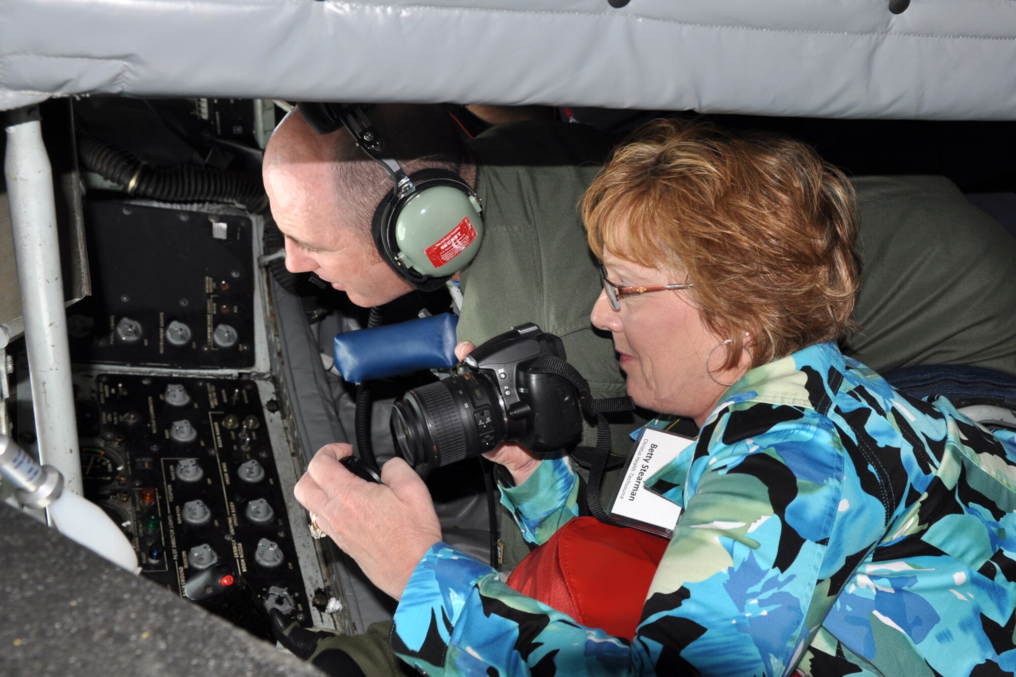 Betty Stearman, Christus Health-Techsource, takes photos as Senior Master Sgt. Ray Lewis, boom operator, 18th Air Refueling Squadron, McConnell Air Force Base, Kan., maneuvers the KC-135 Stratotanker’s refueling boom into position during the Employer Appreciation Day flight April 2, 2011. Employers of wing Reservists where invited to be part of the flight refueling A-10s and B-52s, followed by a briefing from the Employer Support of Guard and Reserve, during the wing's biennial Employer Appreciation flight. (U.S. Air Force photo/Master Sgt Mary Hinson)