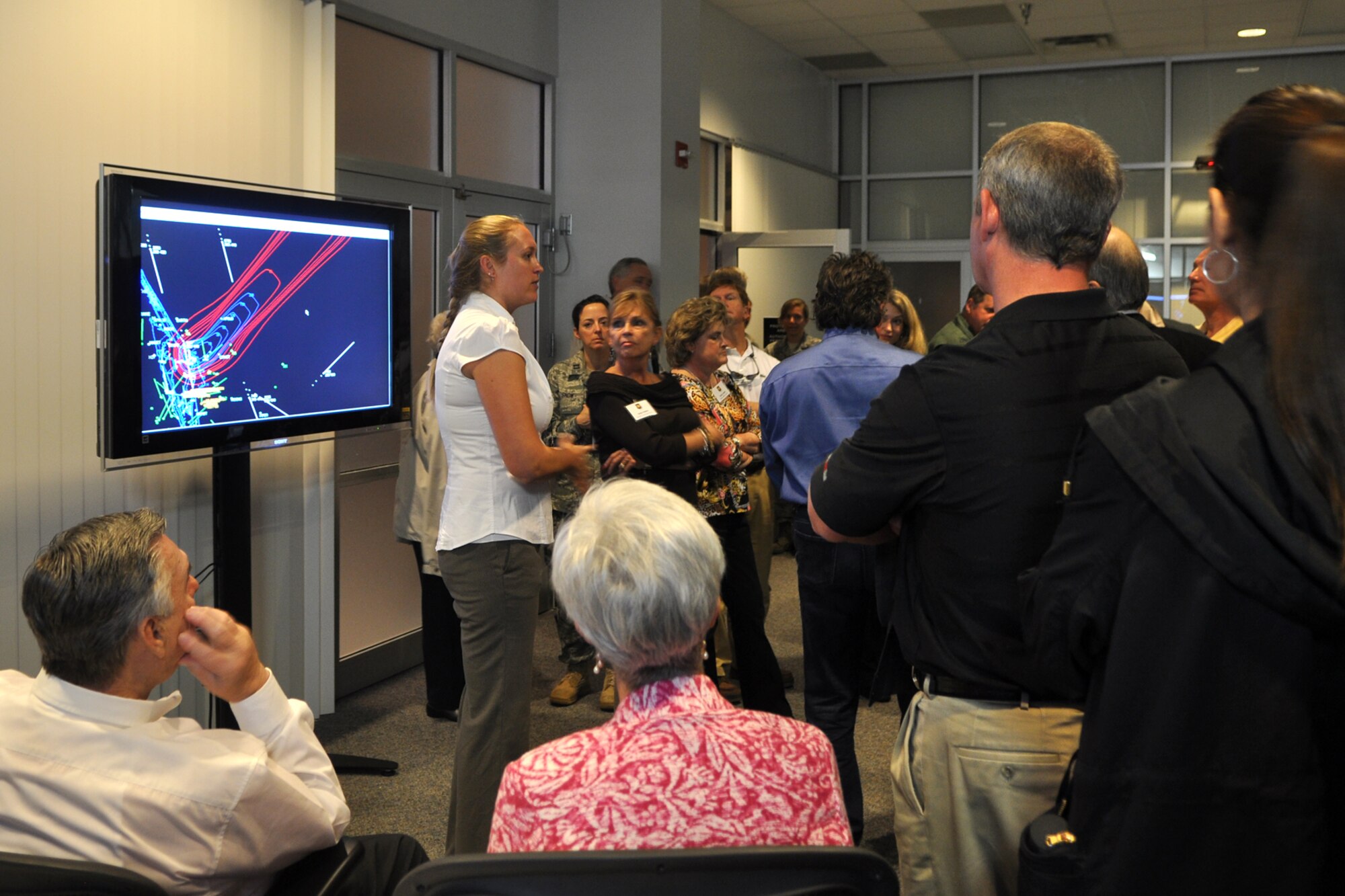 Ms. Jessica Deevers, surveillance control officer, 45th Space Wing, explains her duties in reference to surveillance control for boats and aircraft in the area prior to launch of a space shuttle for a group of civic leaders during their visit to the Morrell Operations Center at Cape Canaveral Air Force Station, March 31, 2011. The center was recently renamed the Morrell Operations Center in honor of the late Maj. Gen. Jimmey R. Morrell, who was the first commander of the 45th Space Wing. The civic leaders were part of the 307th Bomb Wing Civic Leader Tour to Patrick Air Force Base, Fla. The 307th BW from Barksdale Air Force Base, La., showcased its mission capabilities over a four-day period for local civic leaders as well as the employers and clergy of some the bomb wing’s Airmen during three back-to-back community support events March 30 – April 2, 2011. Civic leaders witnessed the refueling of A-10 Thunderbolts during their flight to Patrick AFB. Once they arrived, they received briefings about the 920th Rescue Wing, 45th Space Wing, and the 301st Rescue Squadron. (U.S. Air Force photo/Tech. Sgt. Jeff Walston)